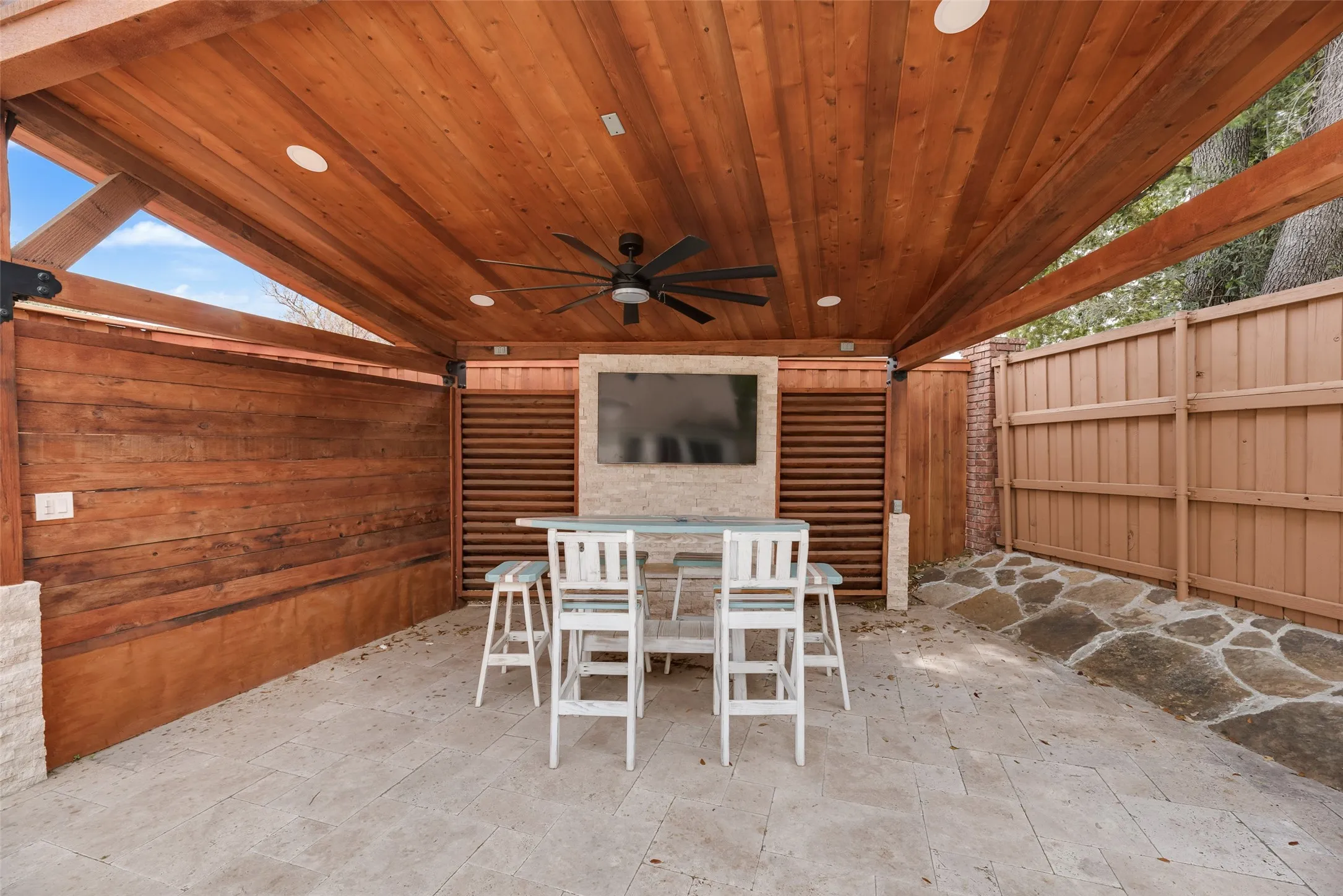 Covered patio featuring a wood-paneled ceiling, recessed lighting, and a ceiling fan