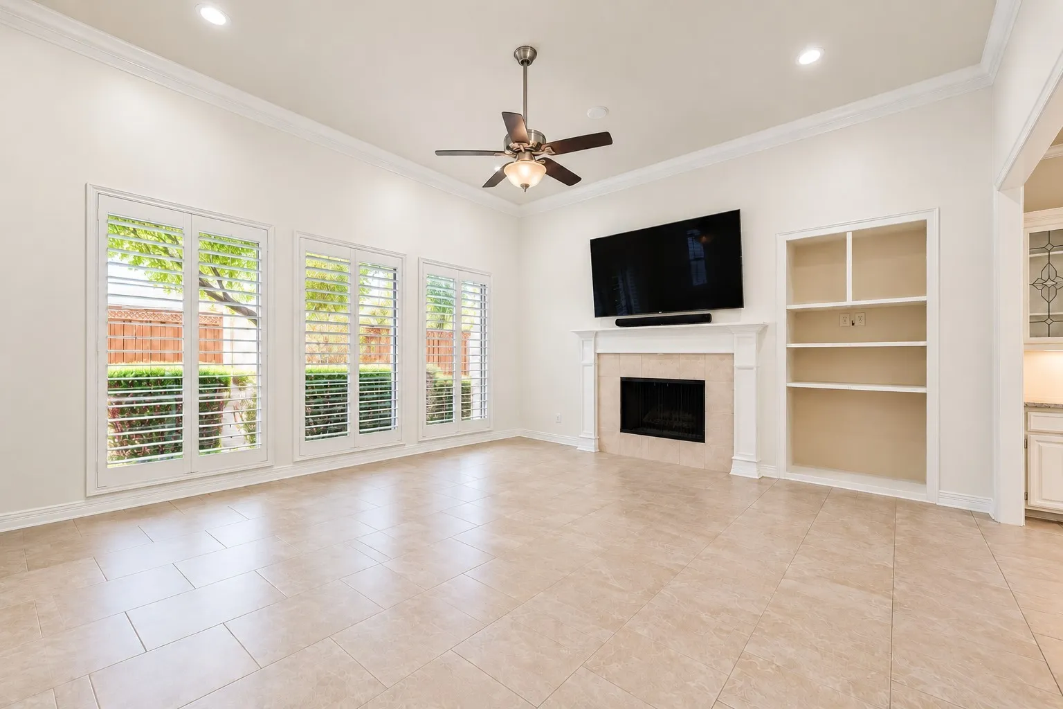 Spacious living area featuring high ceilings, recessed lighting, and a tile floor