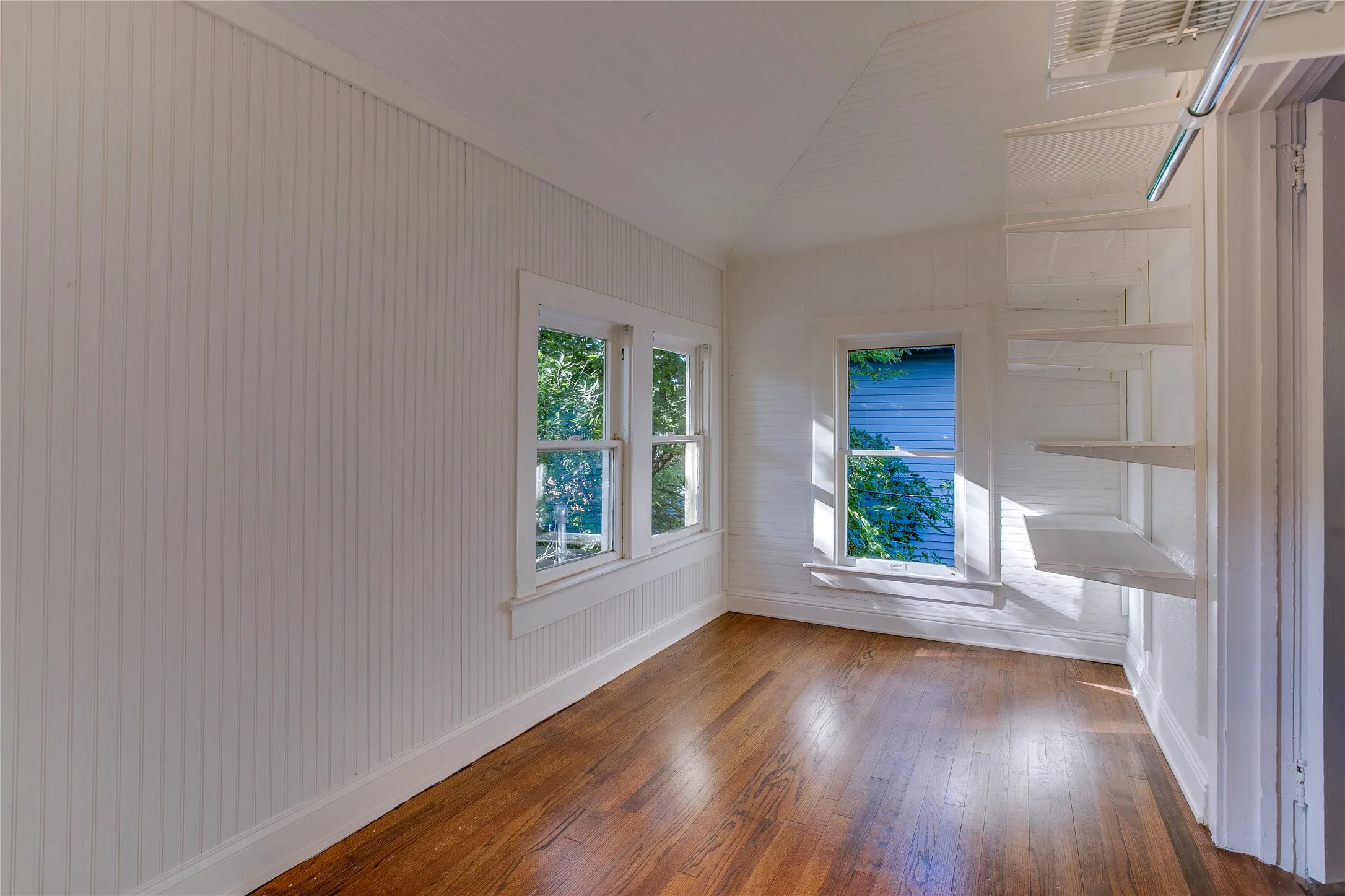 Once an upstairs sleeping porch off the northwest corner bedroom, this space now serves as a huge walk-in closet. Additional Elfa closet materials remain.