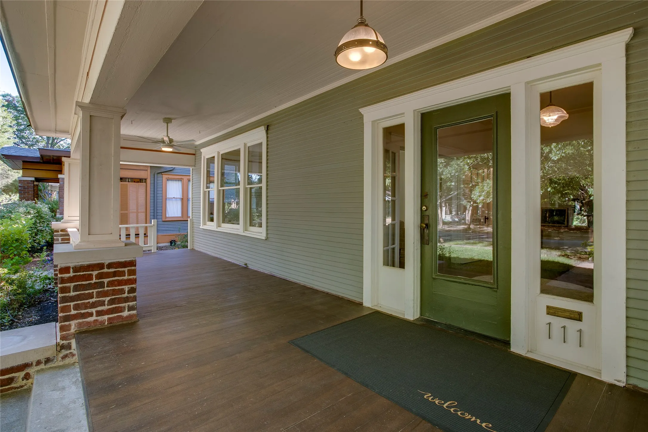 The exterior restoration involved removal of concrete shingles to reveal original wood
siding beneath, reconstruction of brick piers and wood columns for the porch, and
new wood flooring over the concrete porch.