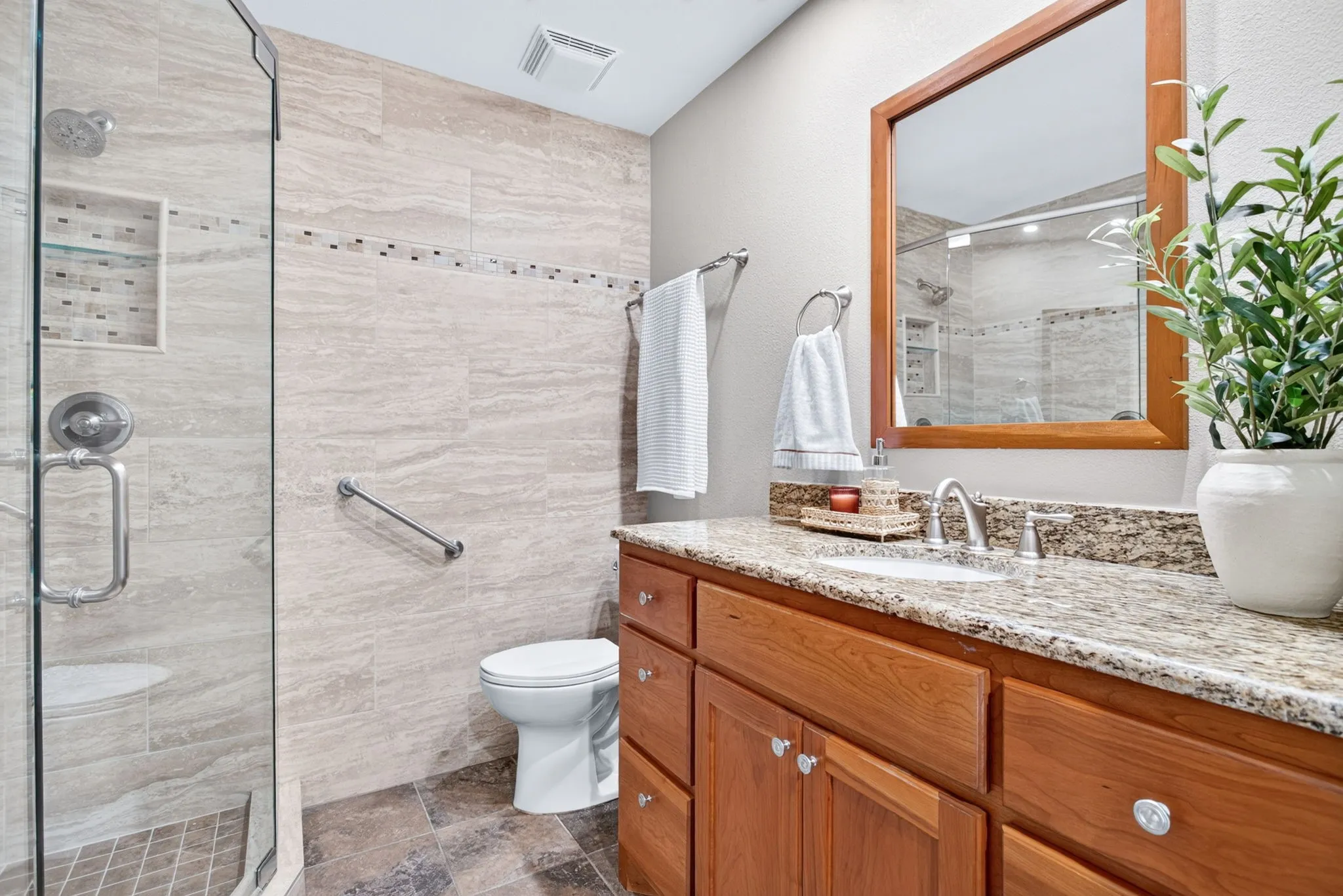 More solid wood cabinetry, custom hardware and fixtures, beautiful wood-framed mirror.