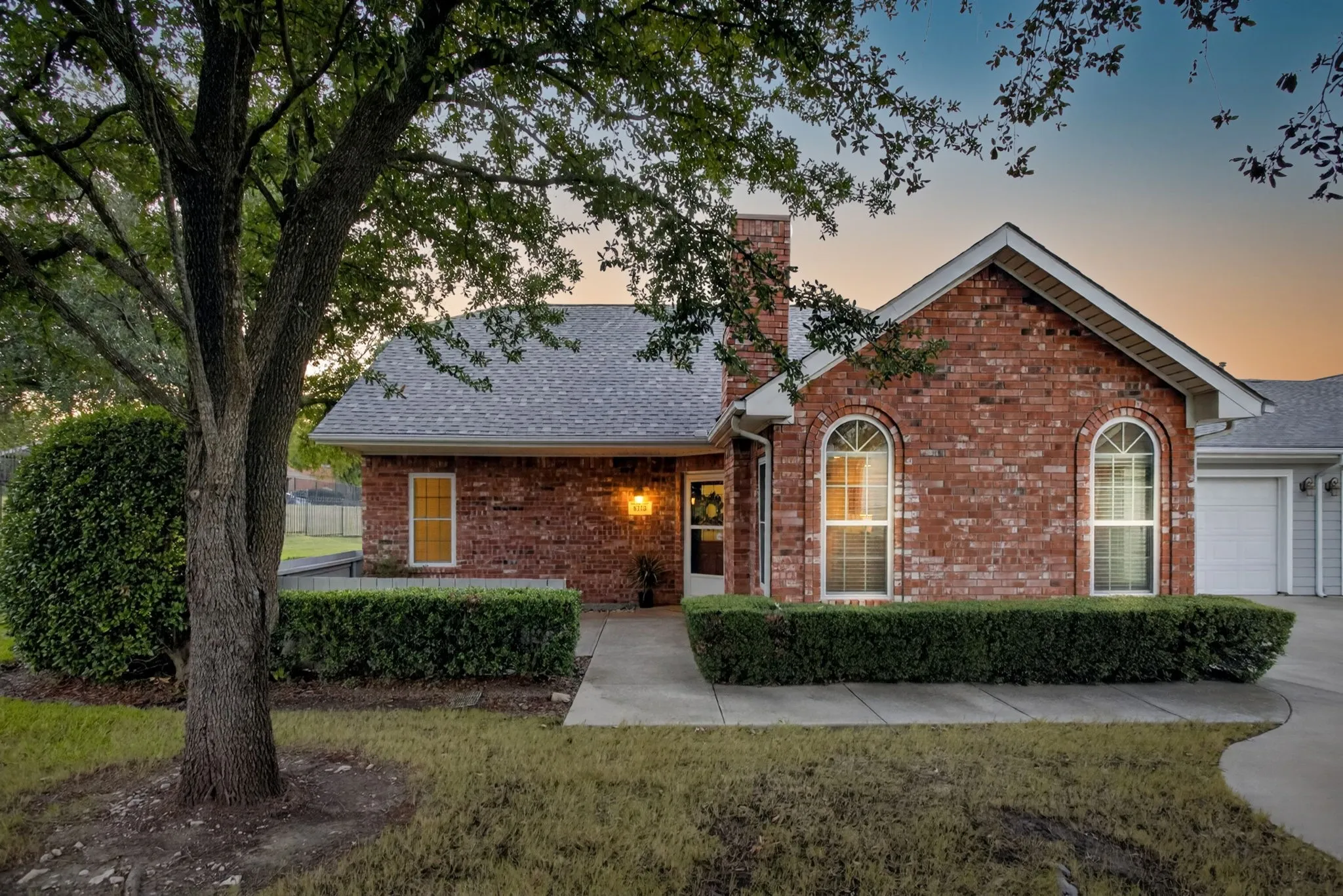 Charming entry with private patio, big shade trees, and a stunning Craftsman style front door.