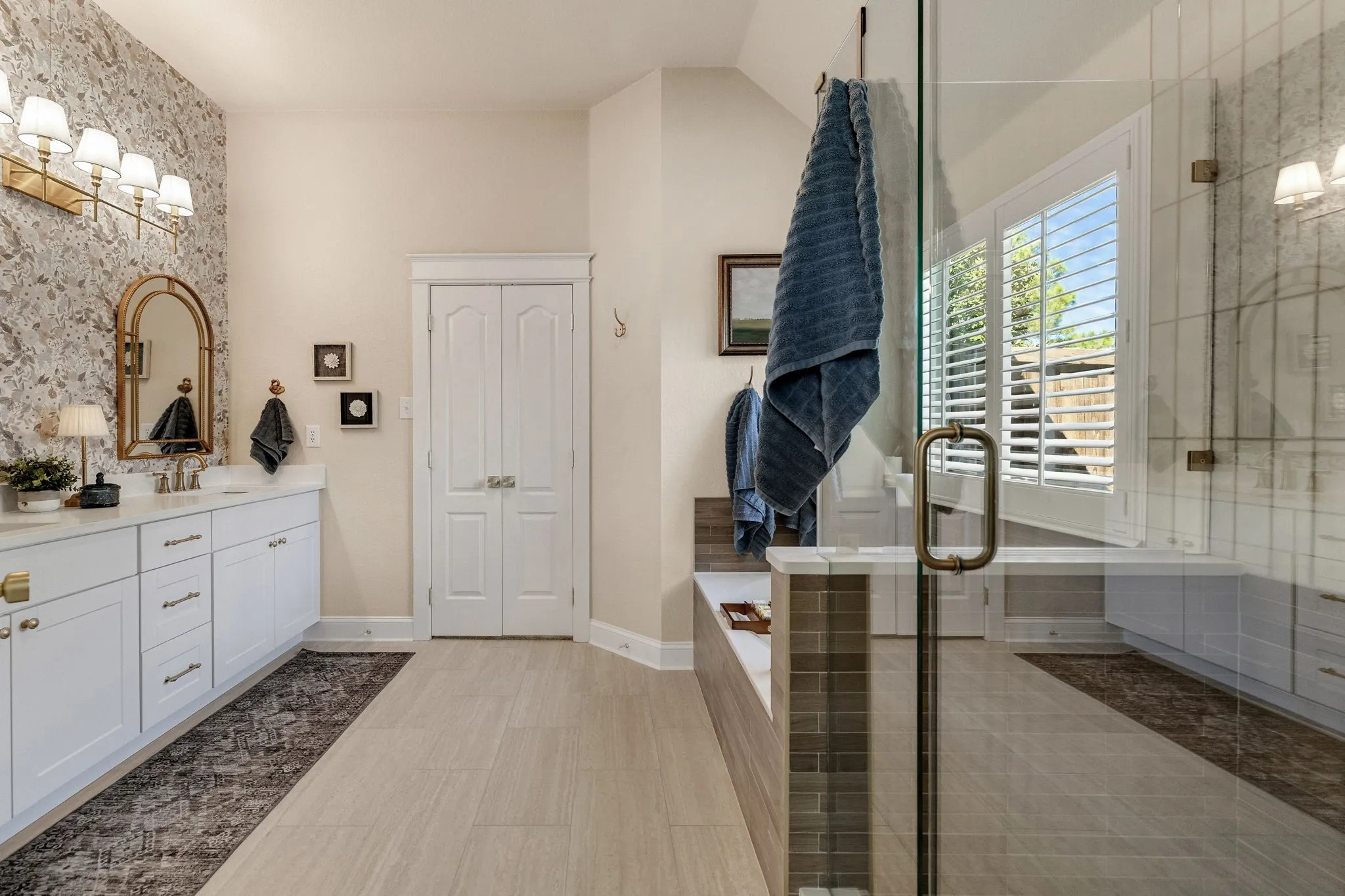 Dual vanity with white cabinetry and gold-tone hardware