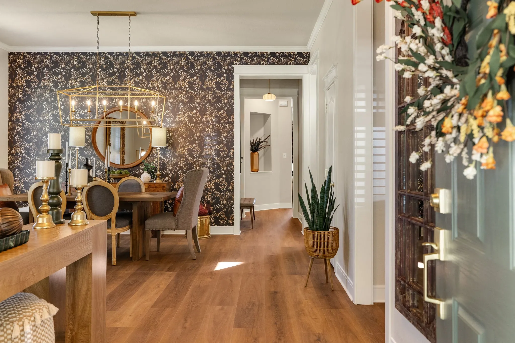 Wood-finish flooring throughout, decorative accent wall, recessed lighting, and a modern chandelier