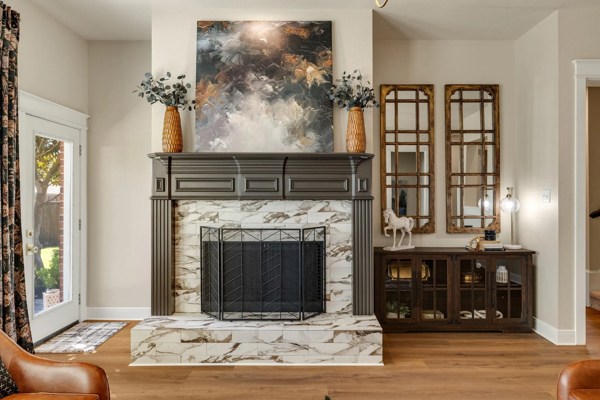 Fireplace with dark wood mantel and decorative tile surround