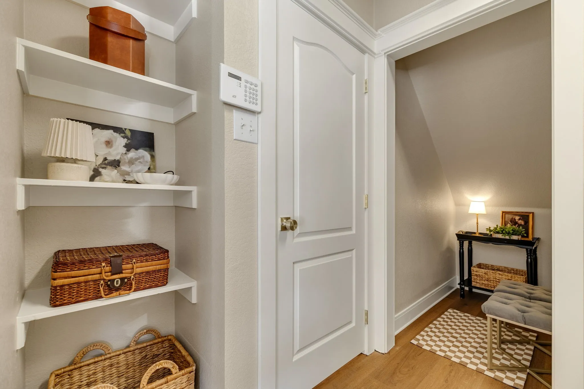 Built-in shelving, panel door, wood-finish flooring, and crown molding