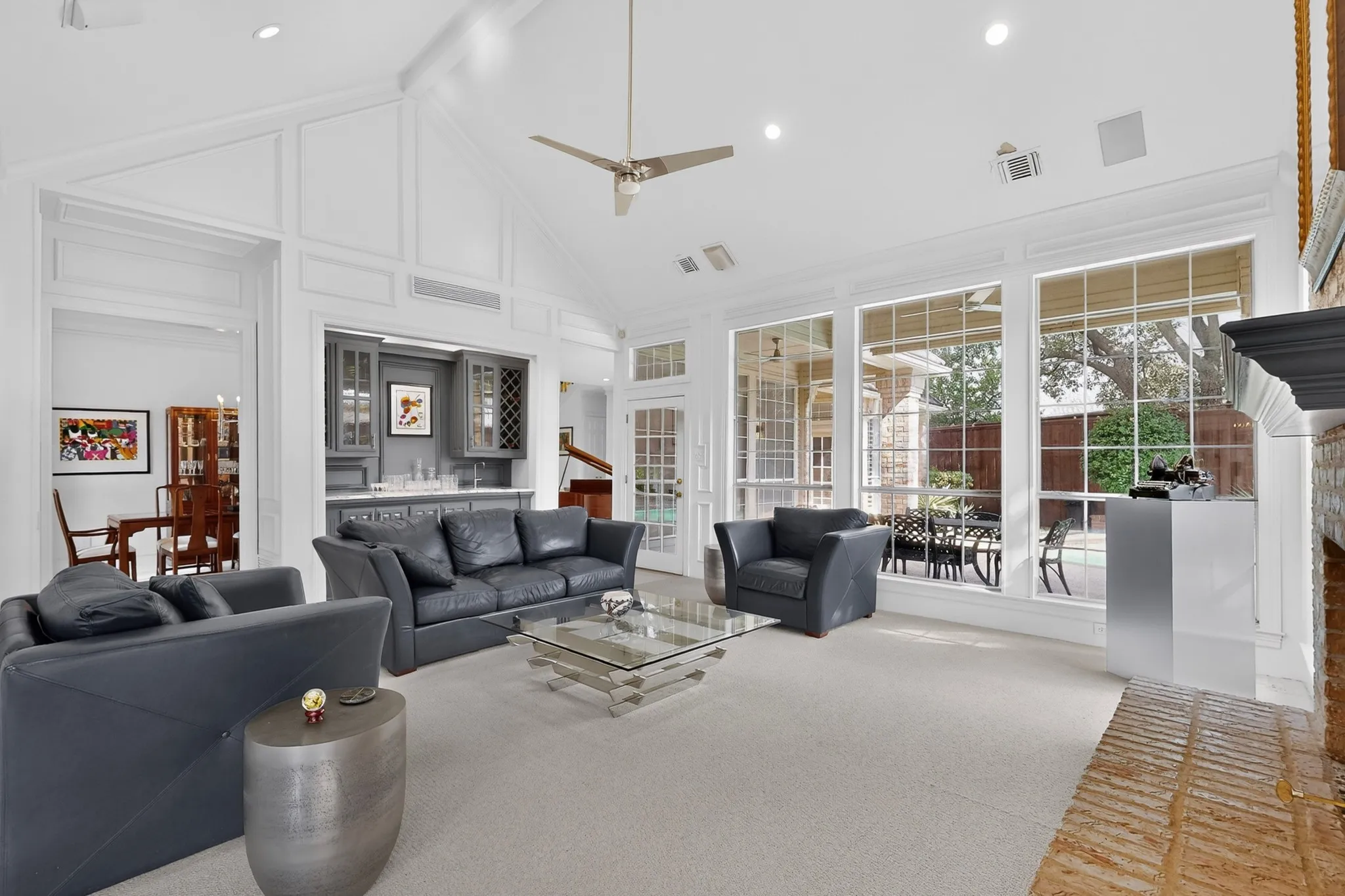 Vaulted ceiling with decorative molding, recessed lighting, and a ceiling fan