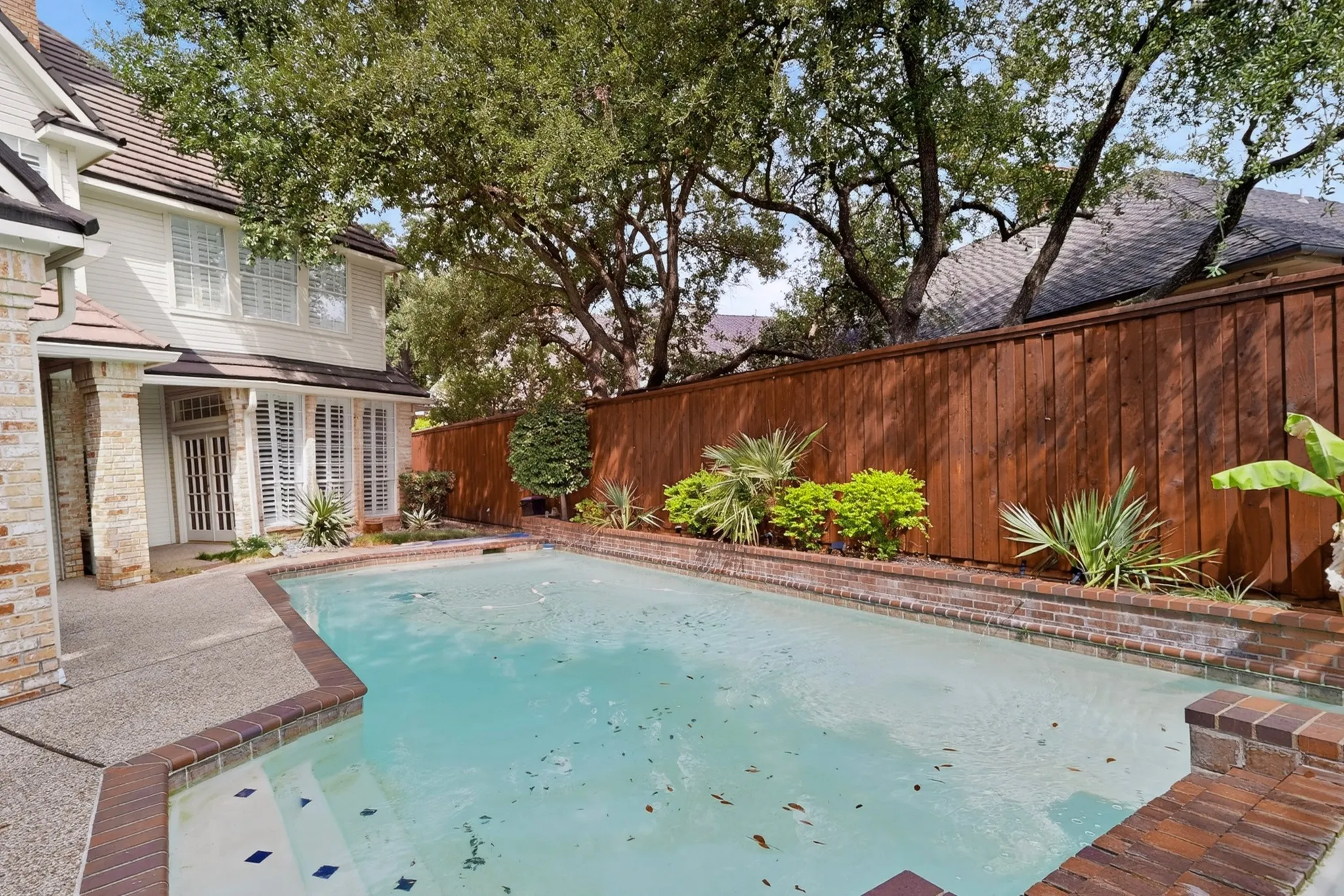 Private swimming pool with brick coping and integrated steps