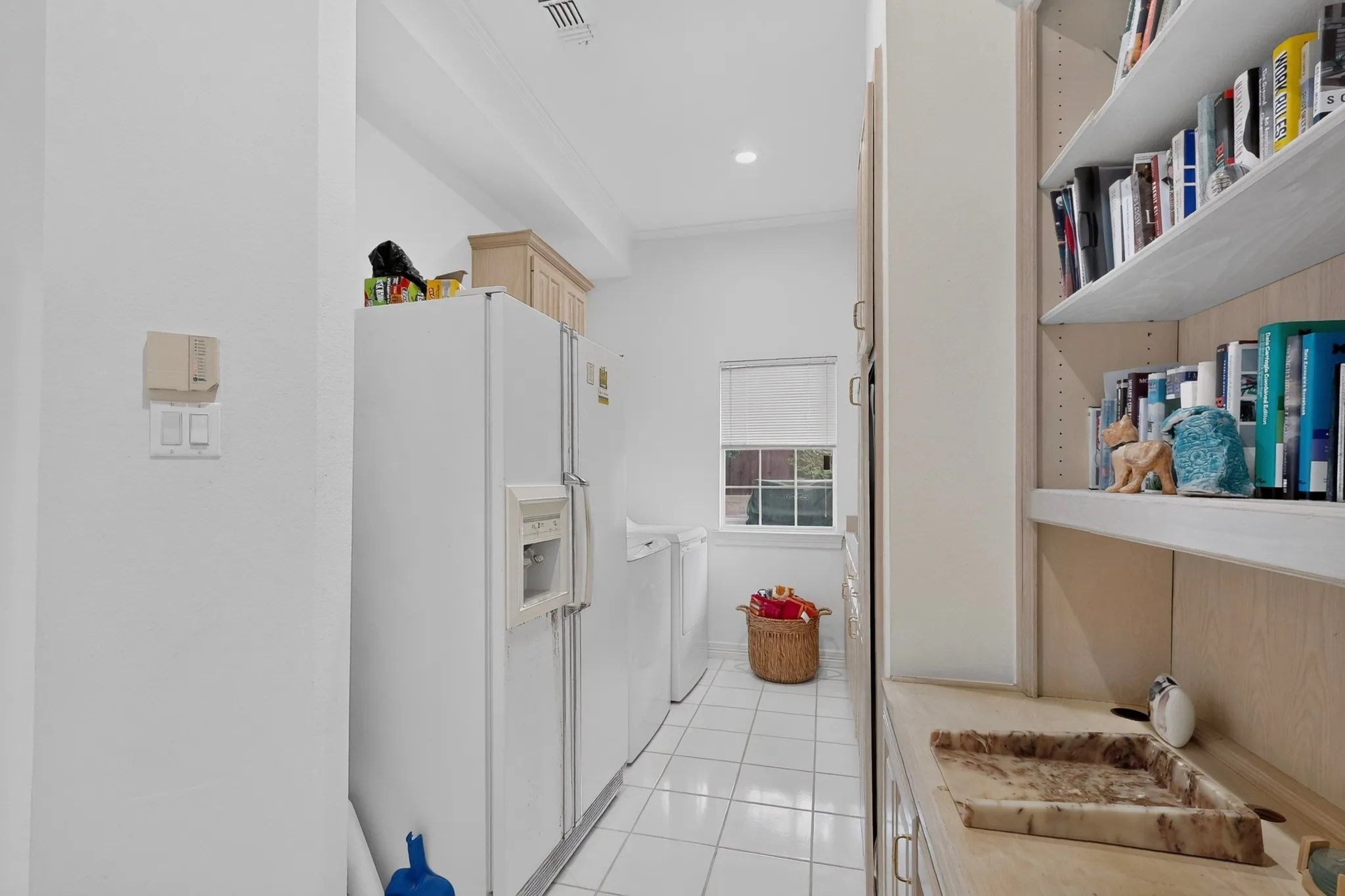 Built-in shelving, integrated countertop, and tiled flooring