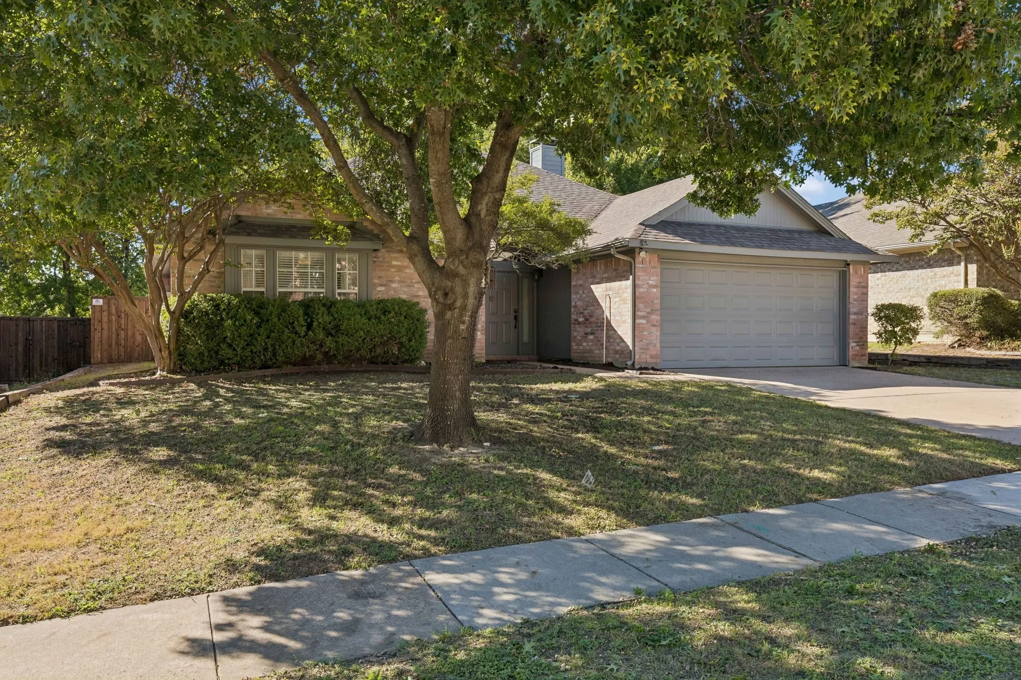 Large lovely shade tree frames this charming home!