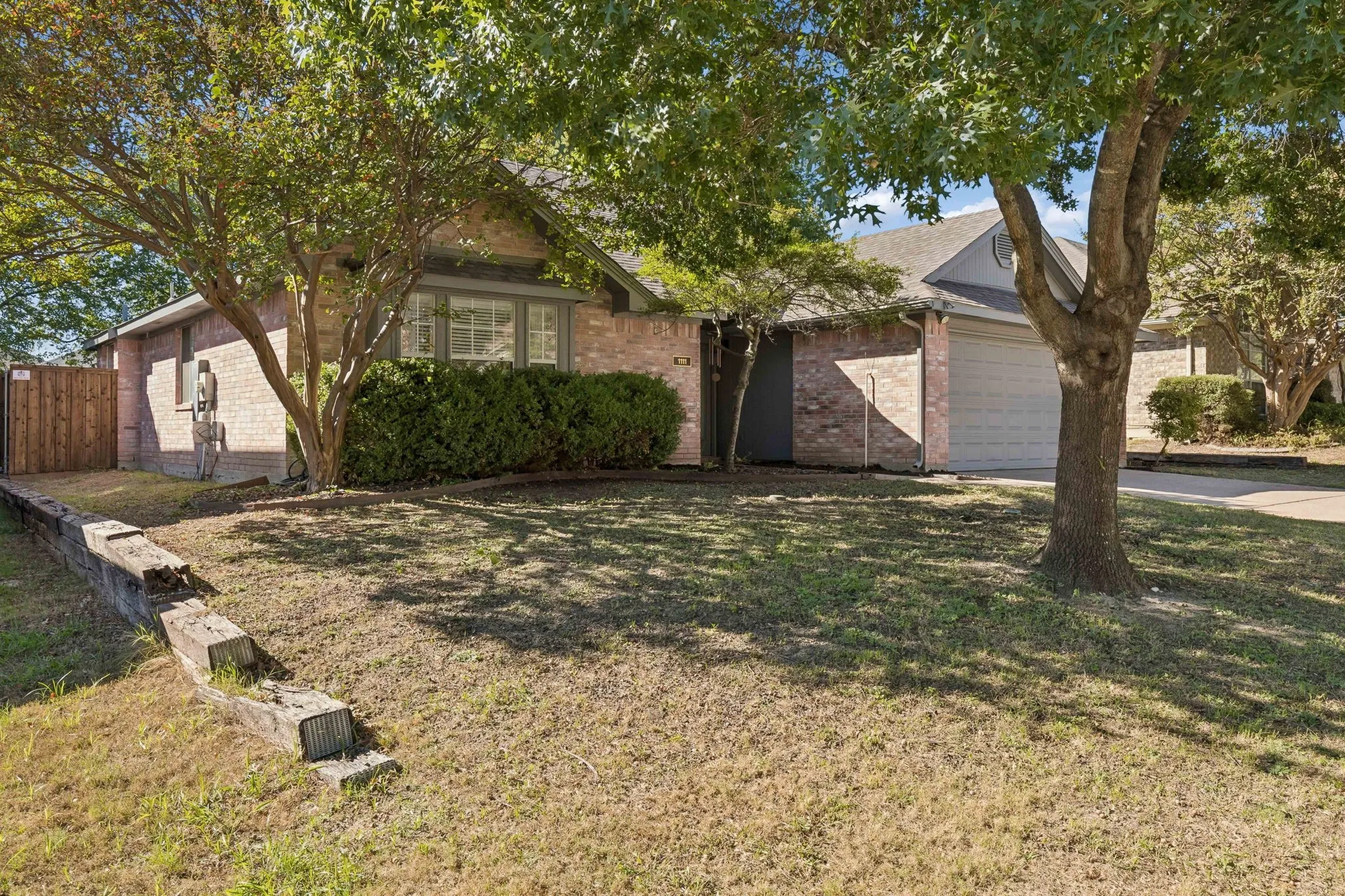 A view of the front of the house displaying the spacious front yard.