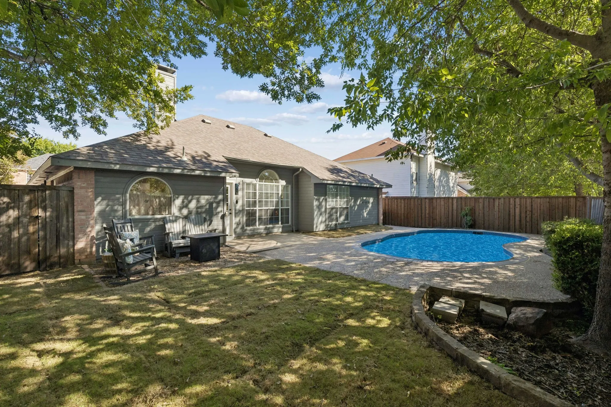 View of the backyard showing more of the grassy lawn.