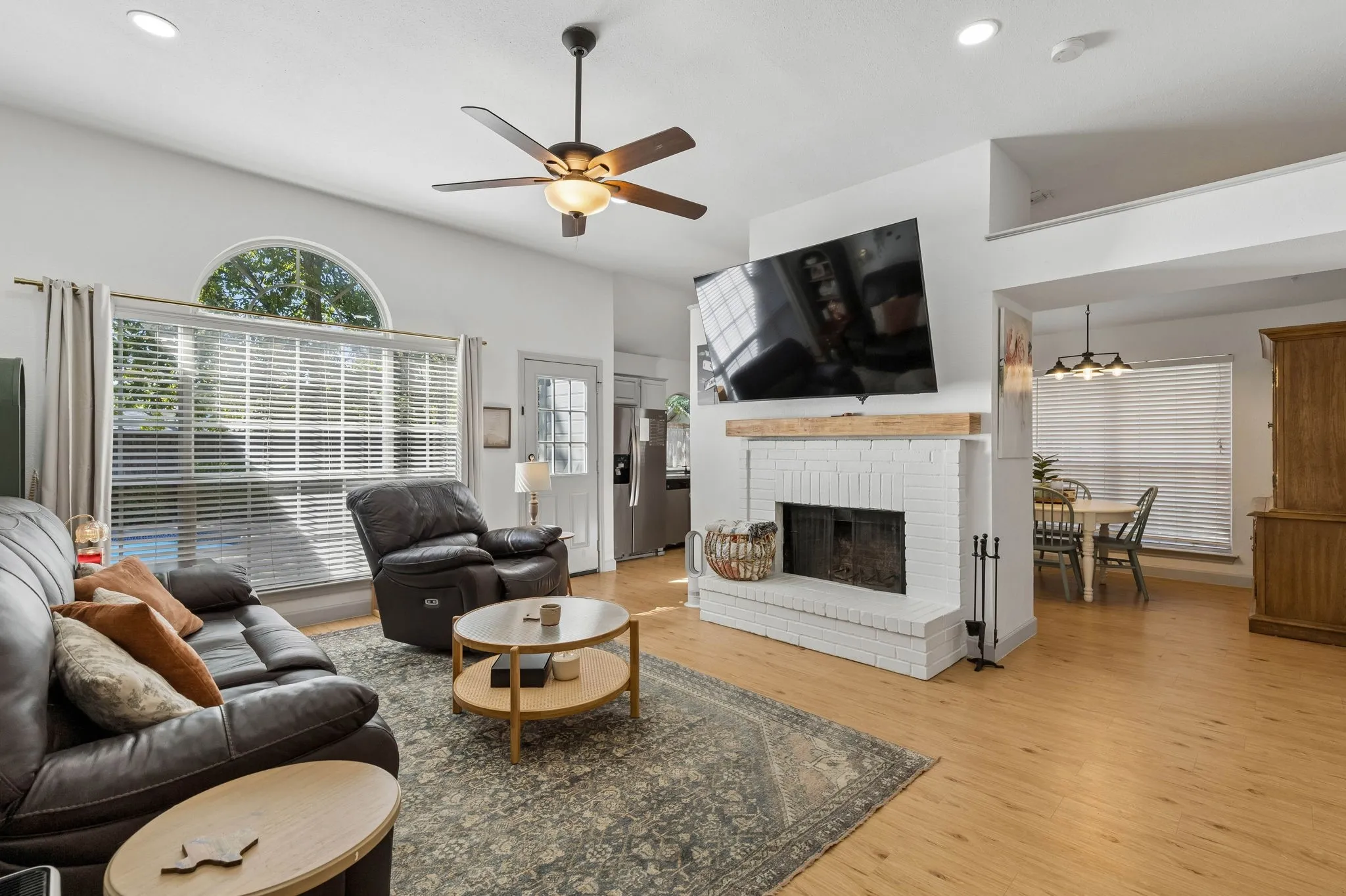 Another view of the living room showing the seamless flow into the kitchen and dining area.
