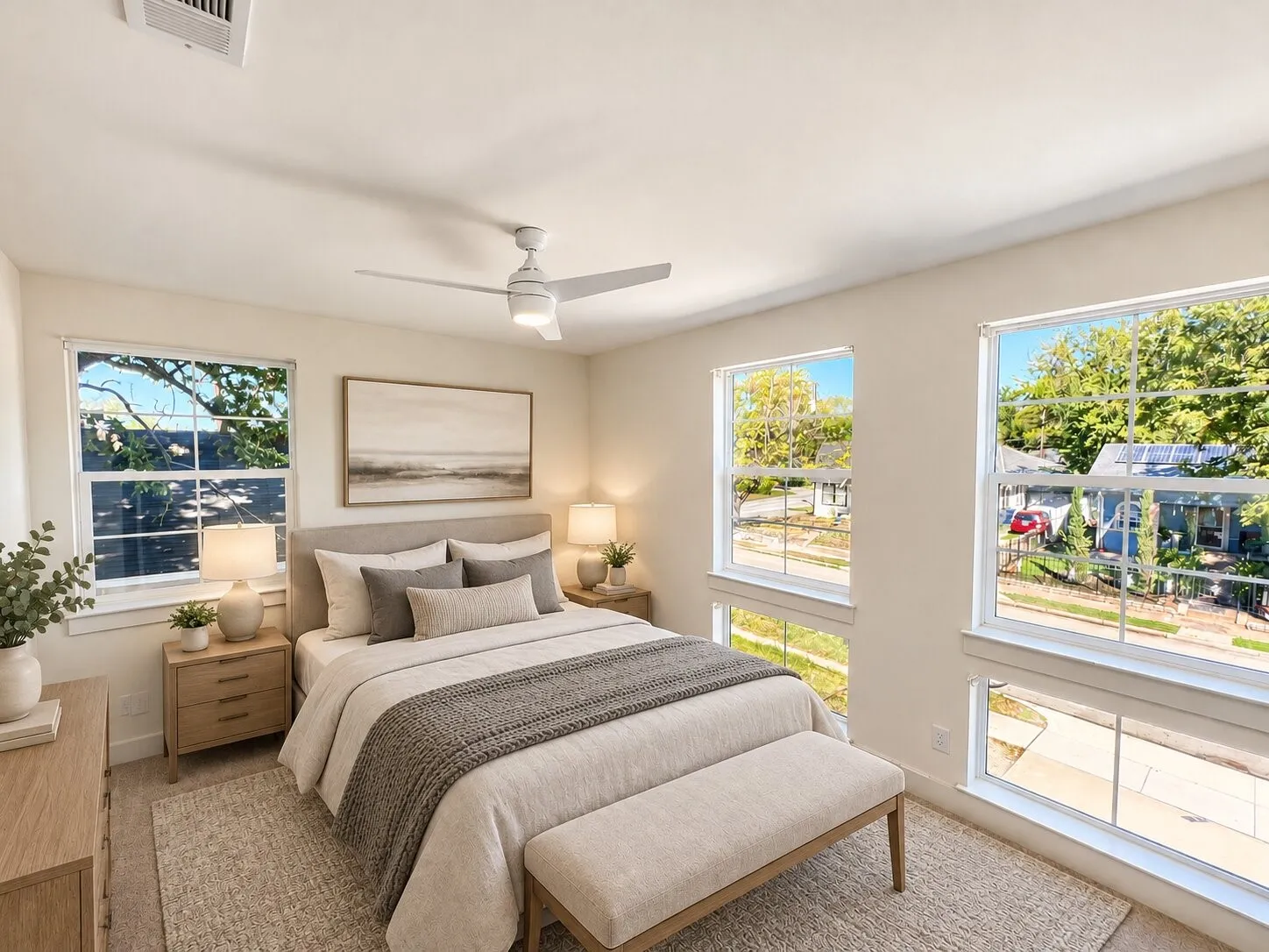 Virtually staged -Multiple large windows, ceiling fan, carpet flooring, and a recessed ceiling vent