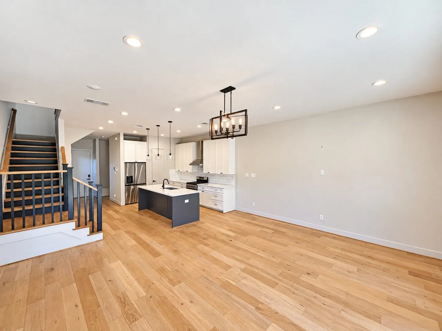 Open-concept living area with wood-finish flooring