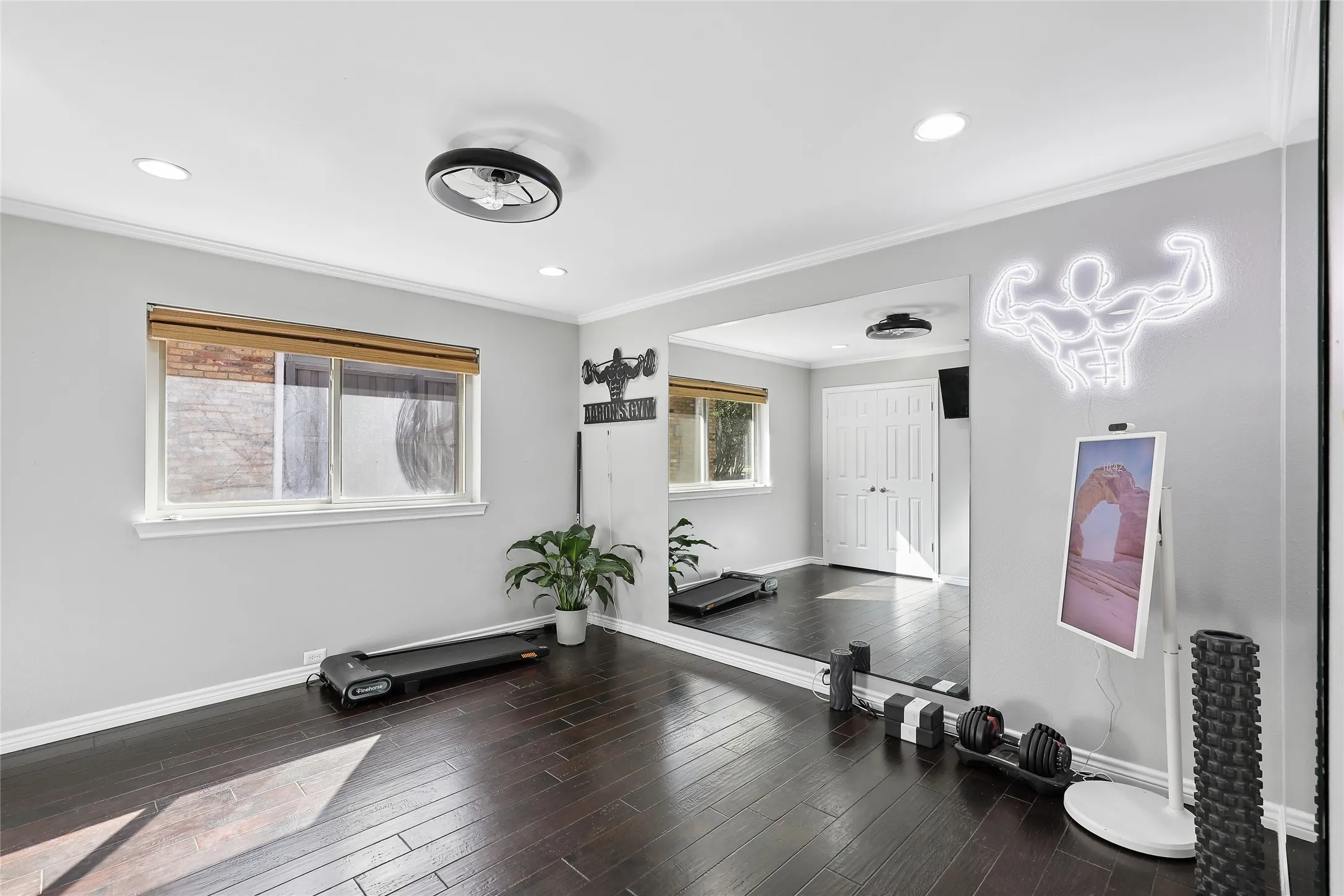 Recessed lighting with a contemporary ceiling fan, wood-finish flooring, and light gray walls