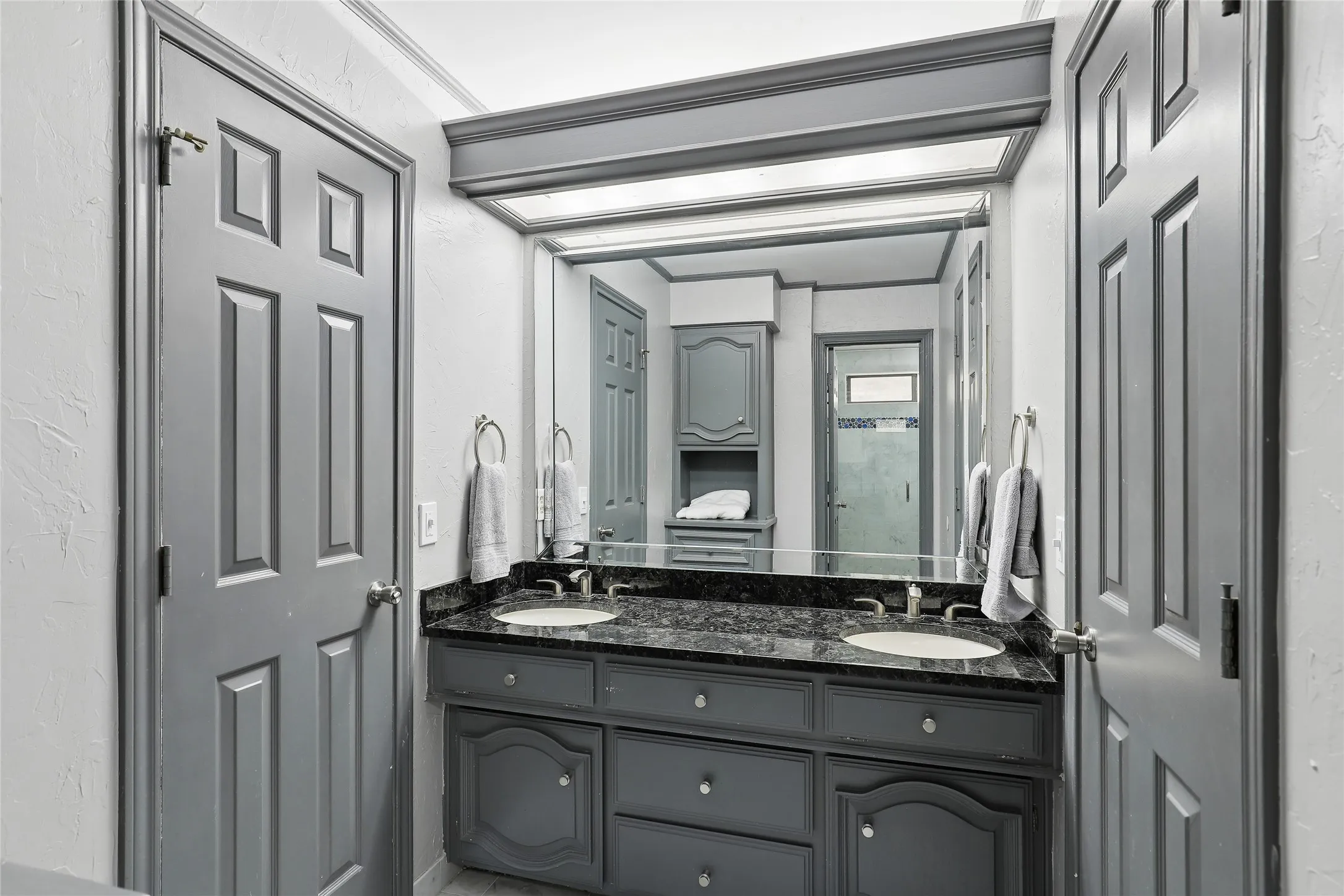 Dual basin vanity with a dark stone countertop