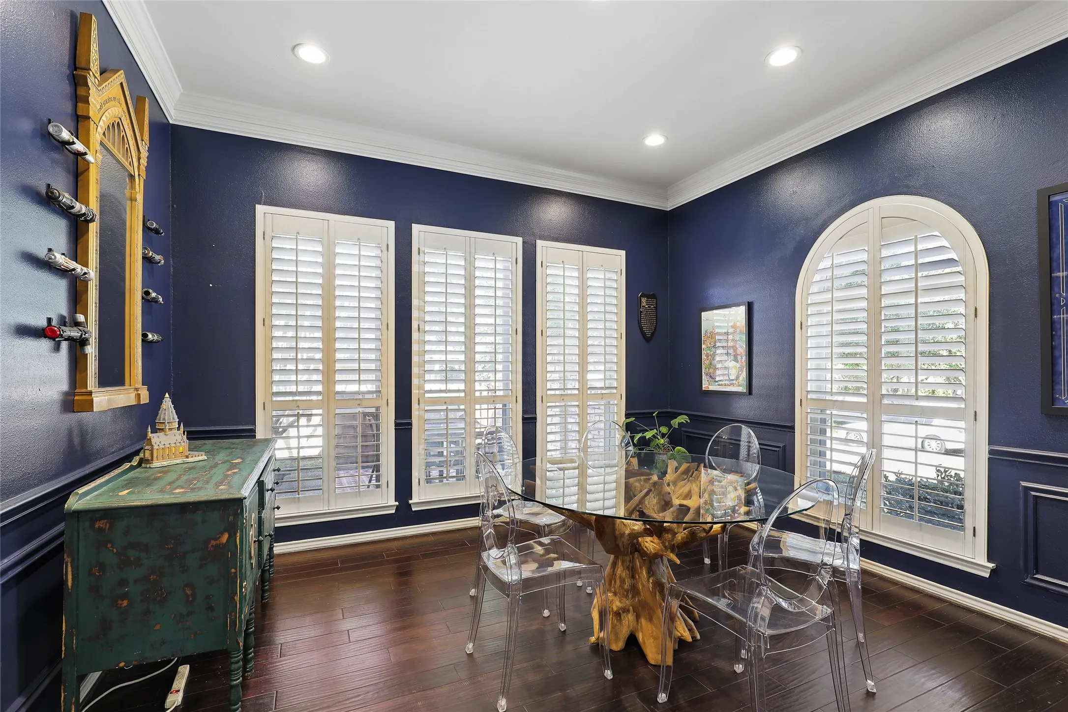 Dark wood-finish flooring, recessed lighting, and crown molding