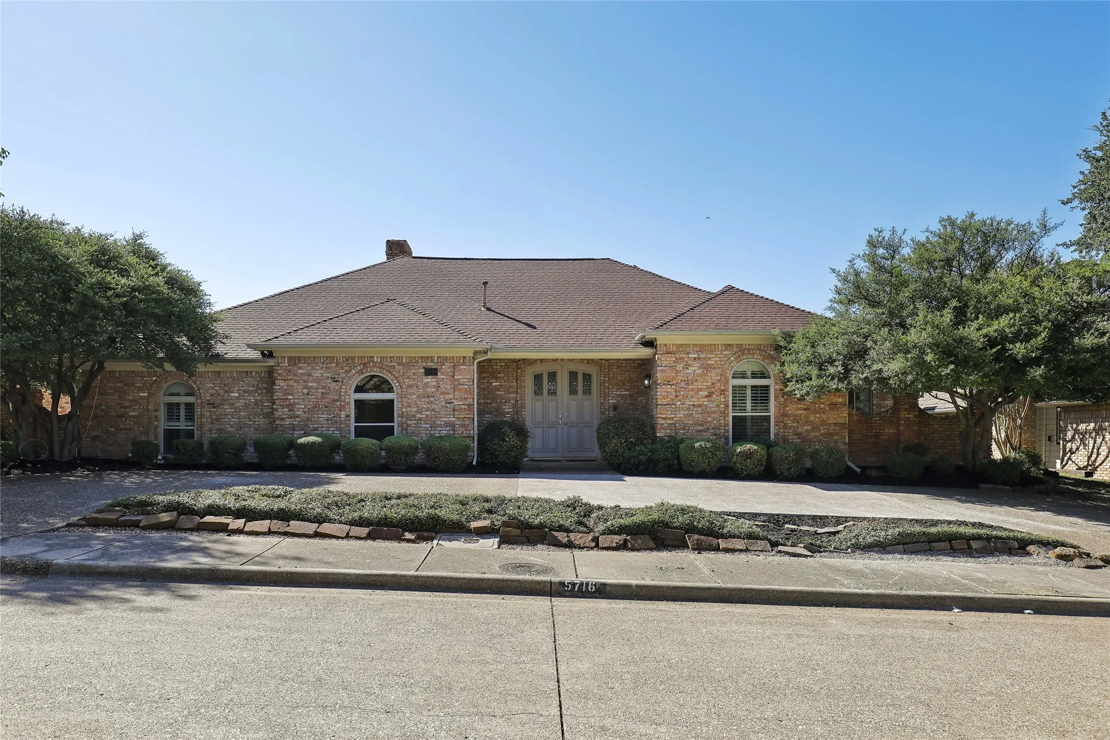 Brick exterior with a gabled roof and arched windows