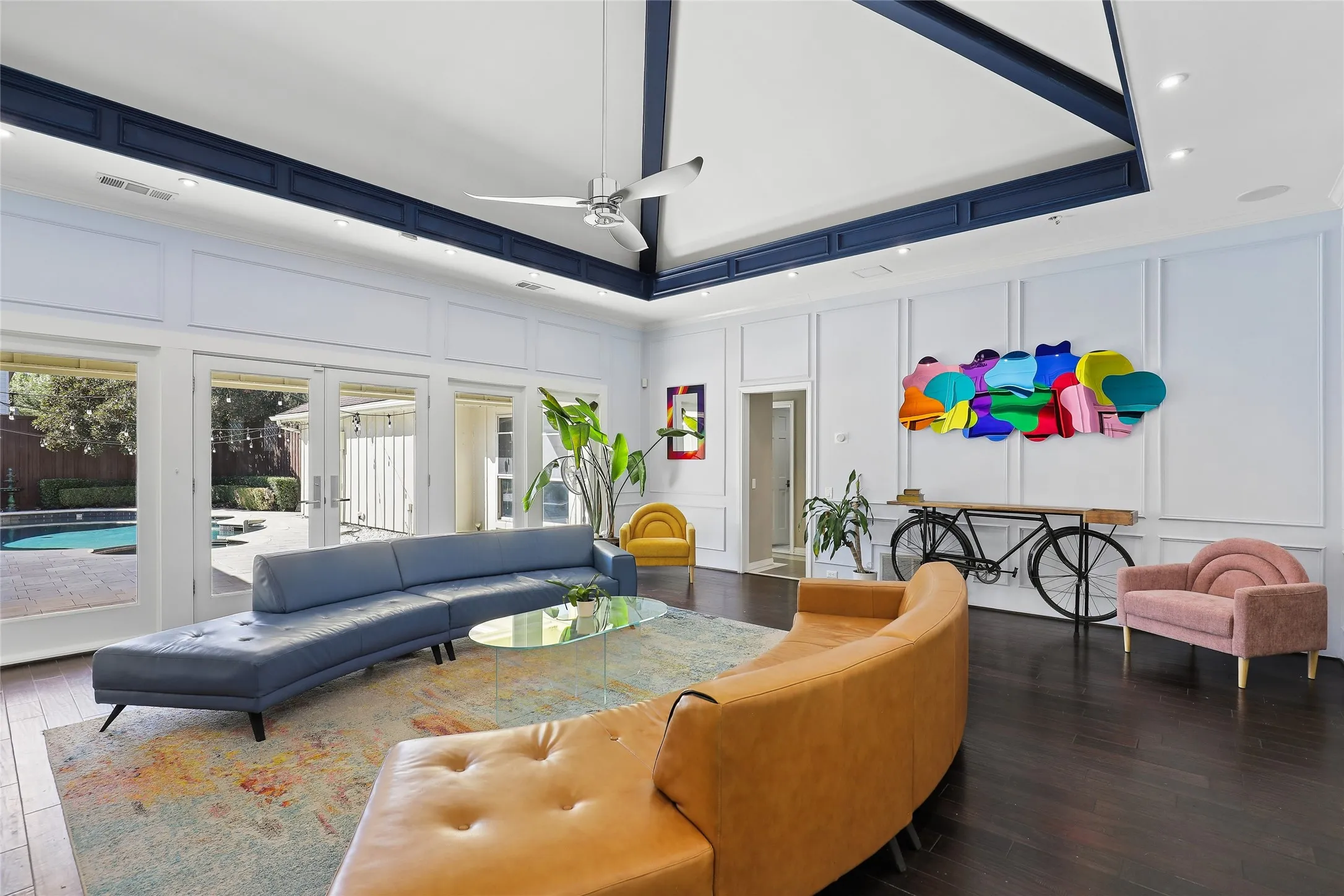 Hardwood flooring, vaulted ceiling  exposed beams, recessed lighting, and wall paneling