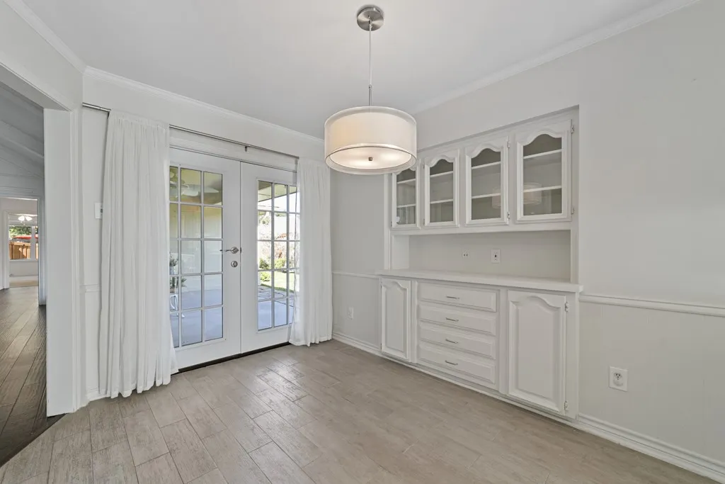 Built-in cabinetry with glass-front uppers and lower storage