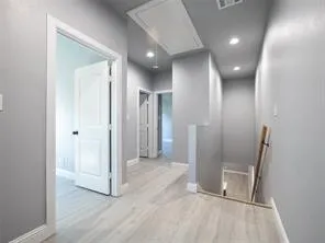 Stair landing is large enough to be an office or play area.