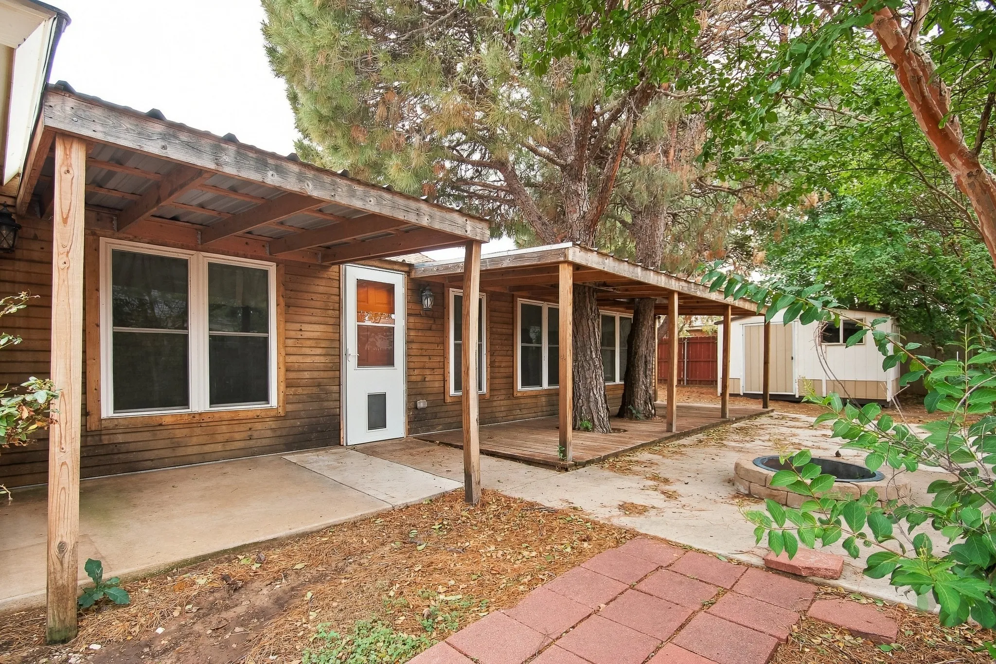 Exterior wood siding with multiple white-framed windows