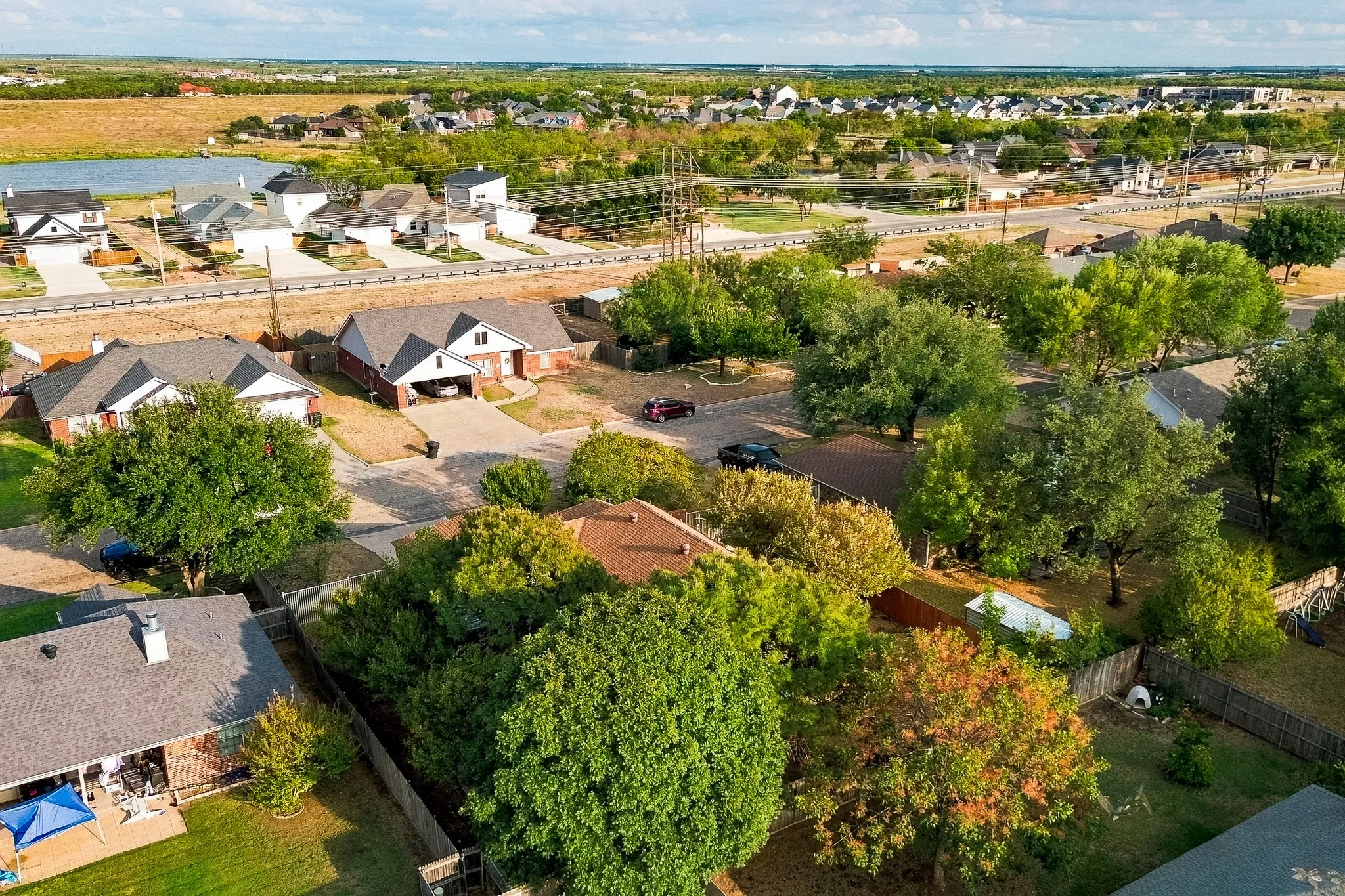 Aerial perspective showcasing residential properties with varied rooflines and mature trees