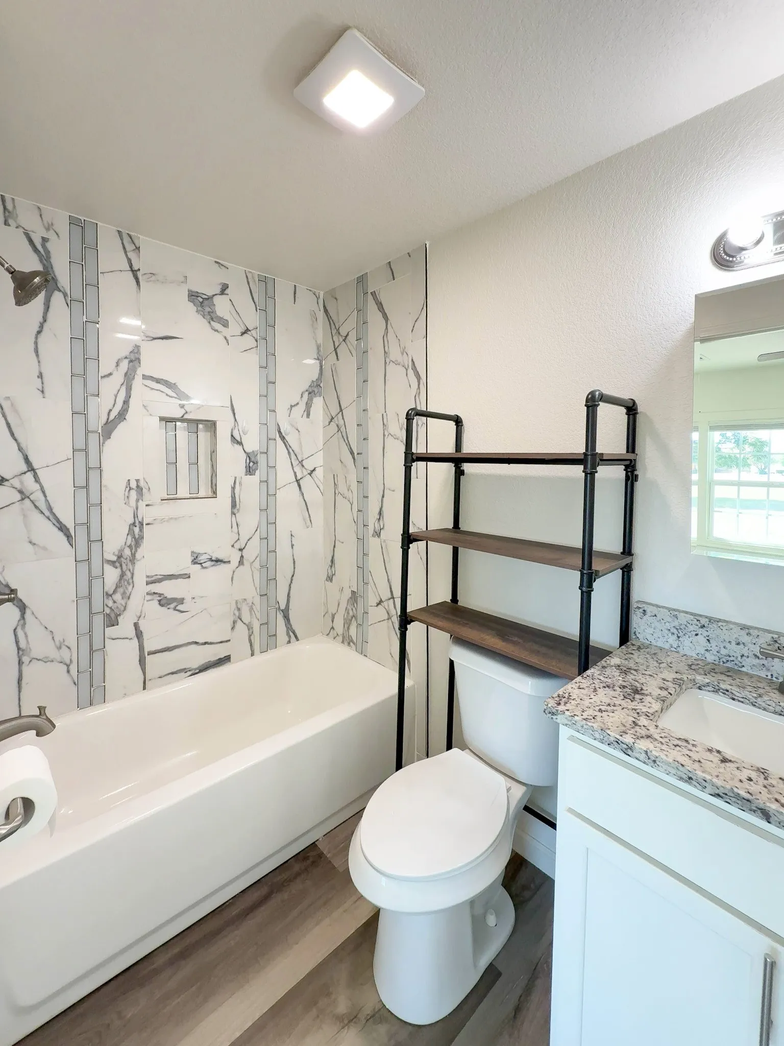 Bathroom vanity with granite countertop and storage rack