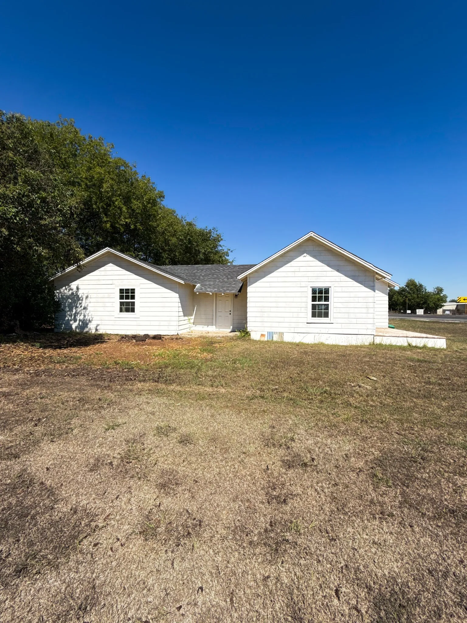 Back view of home exterior and backyard