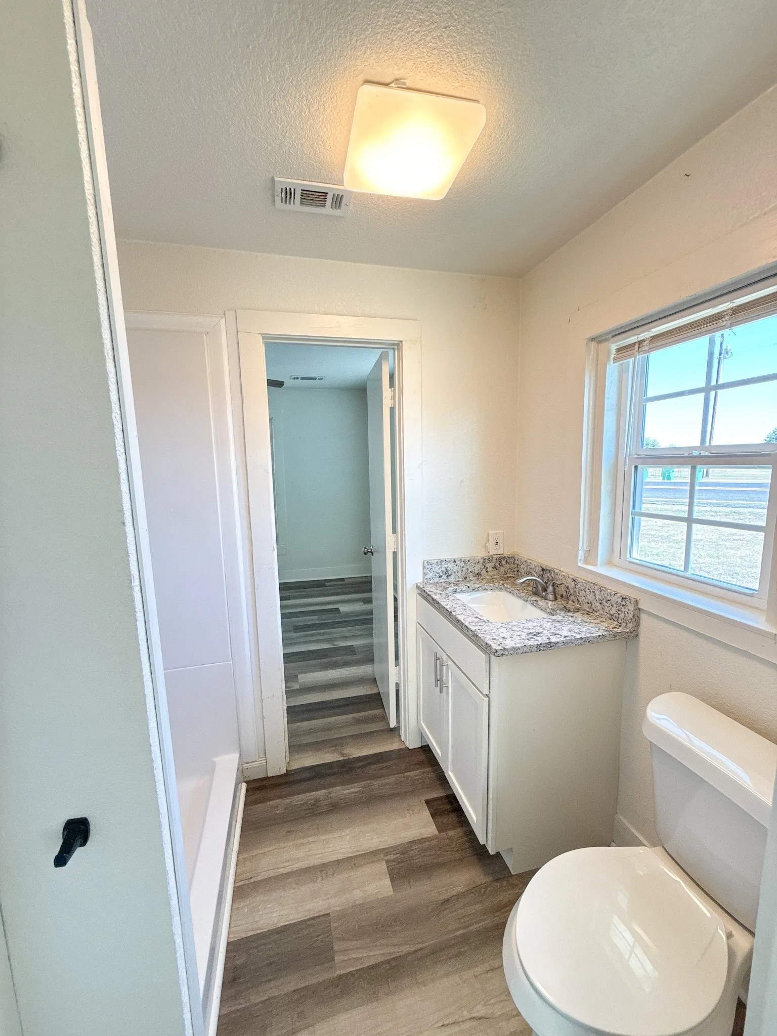 Jack and Jill bathroom with walk-in shower, granite counter tops, and built in cabinets