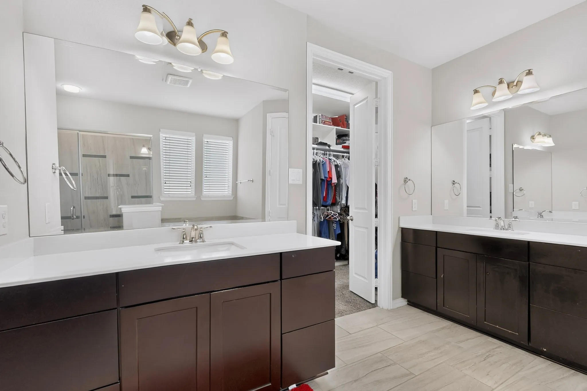 Dual vanities with white countertops and undermount sinks