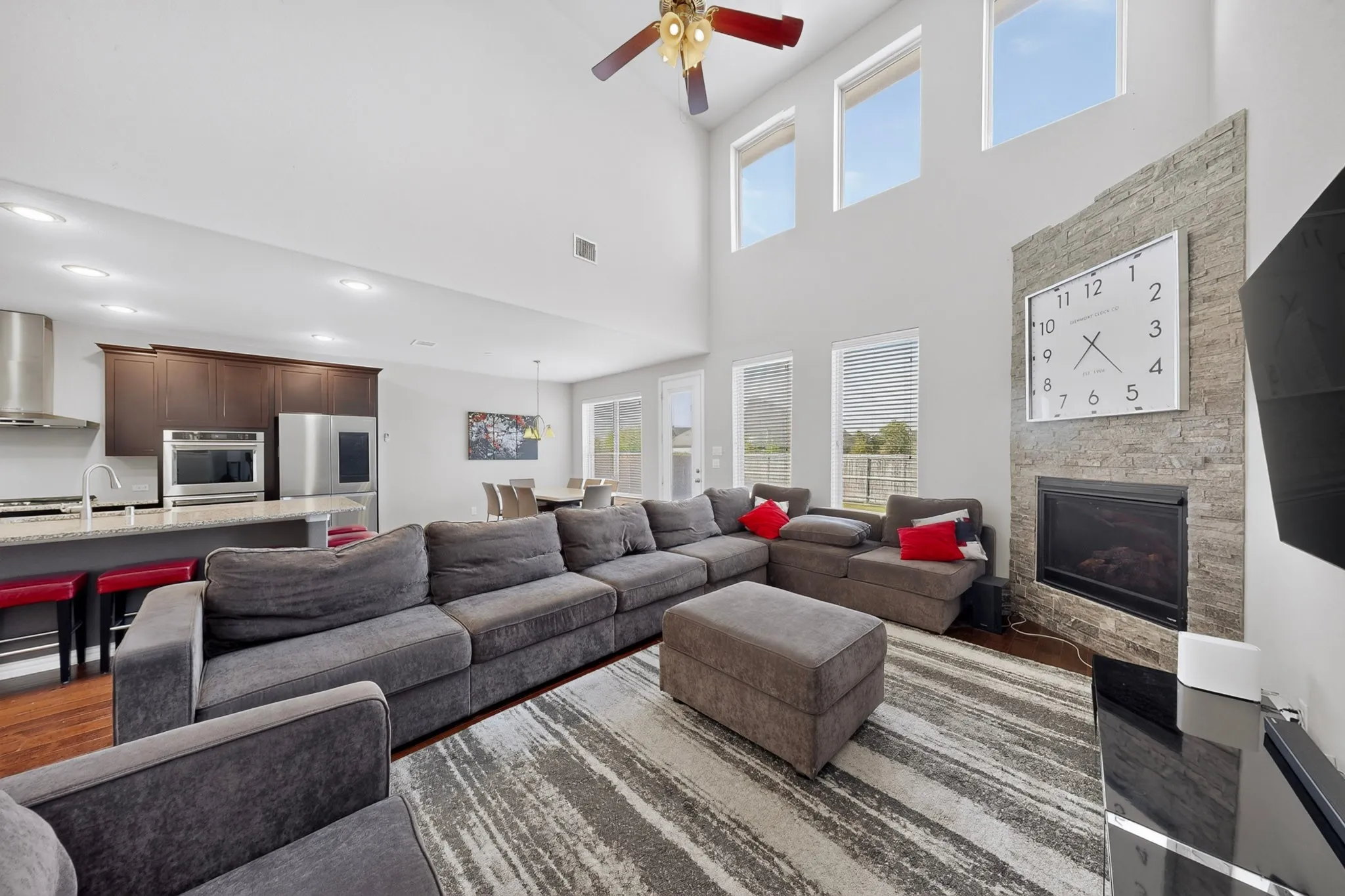 Open-concept living area with soaring ceilings and recessed lighting