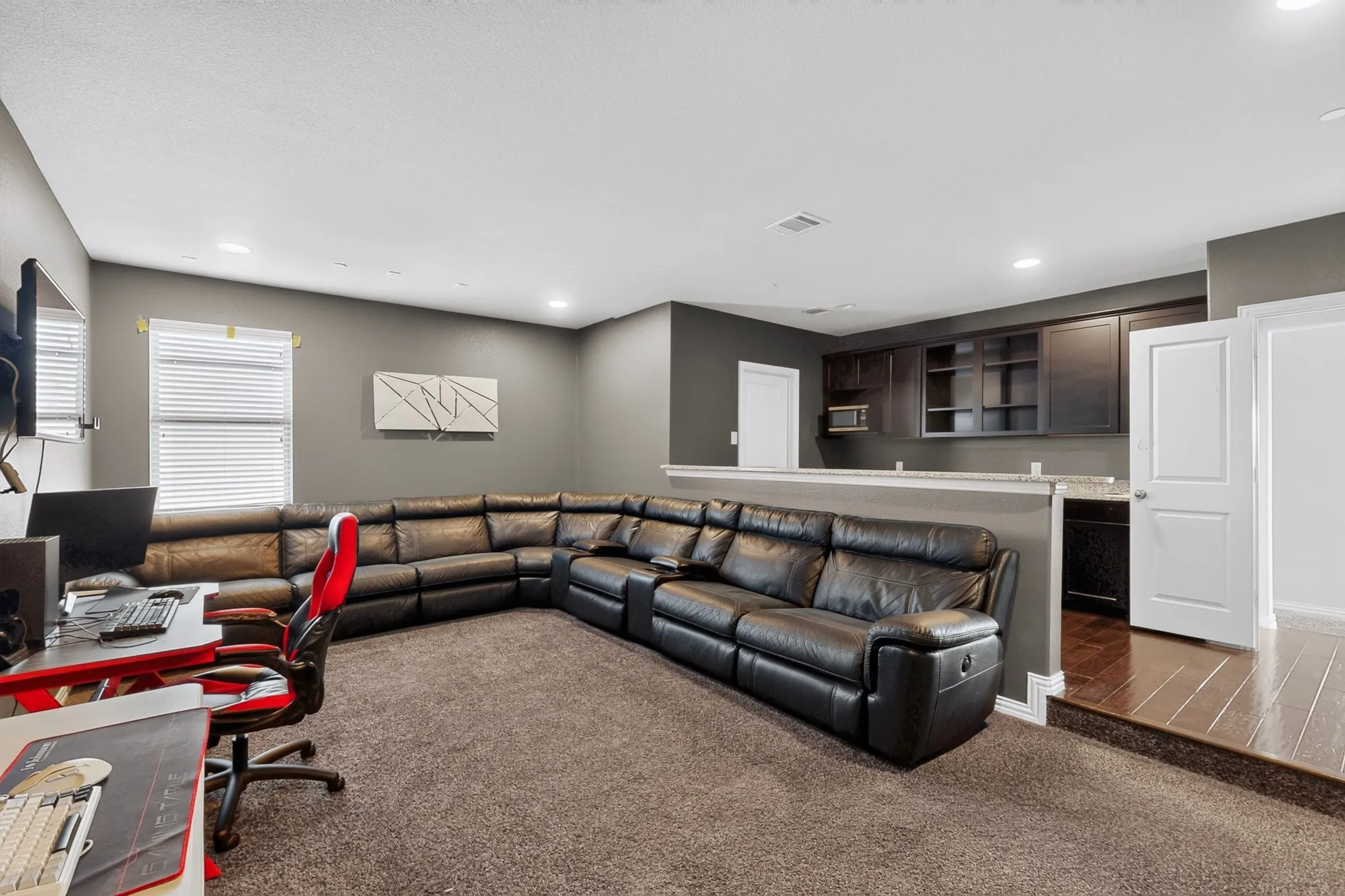 split level media room with serving bar and wetbar