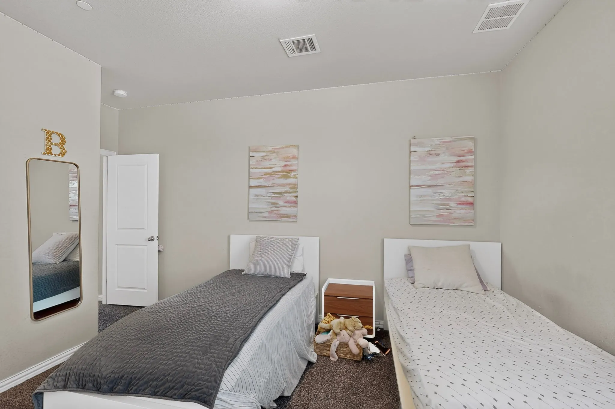Neutral wall paint with textured carpet flooring and white interior doors