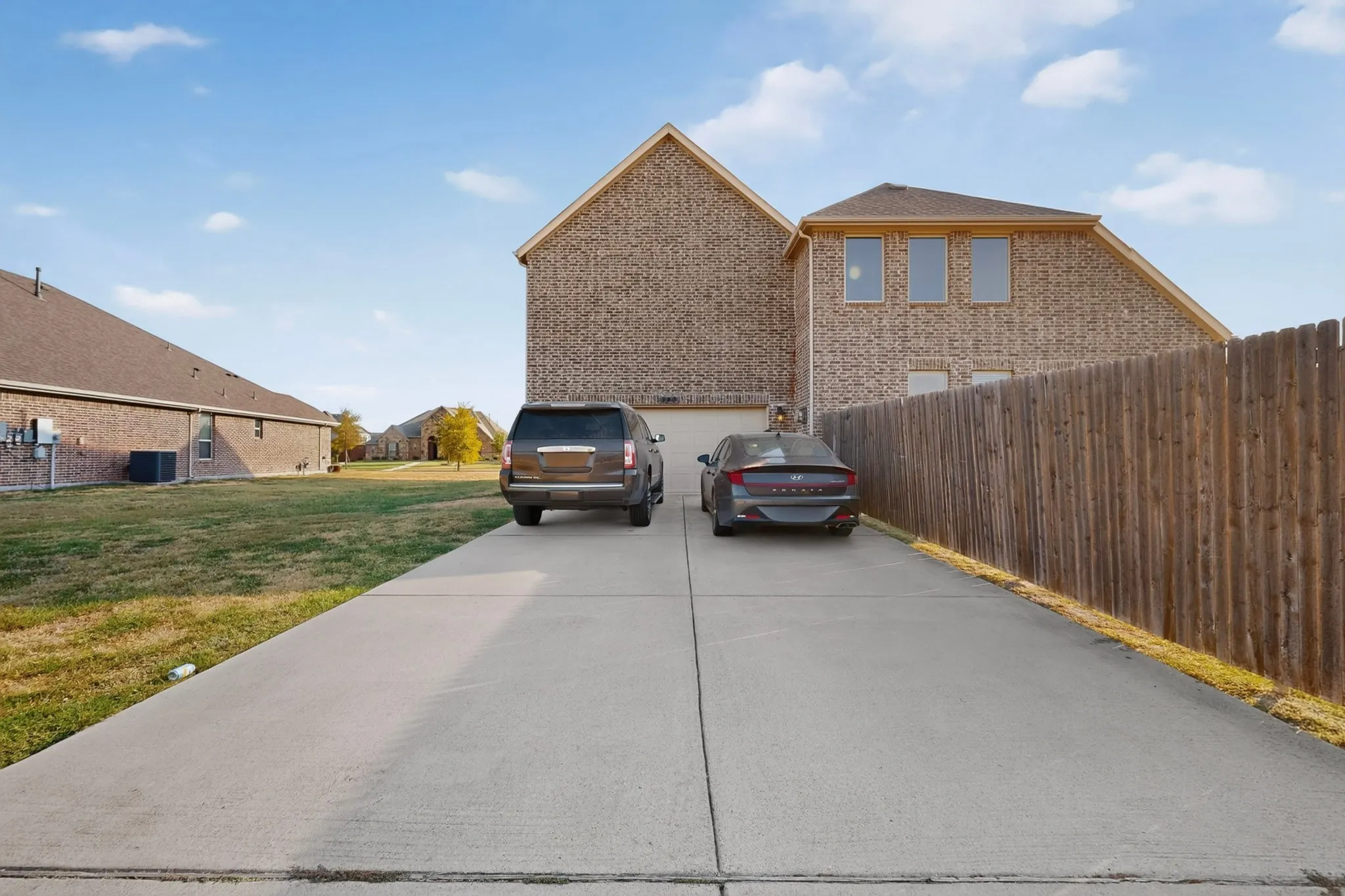 Brick exterior with multiple windows and an attached garage