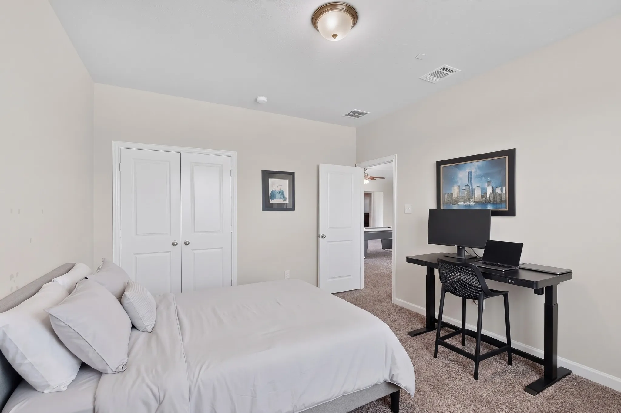 Neutral wall color, carpeted flooring, and a flush-mount ceiling light