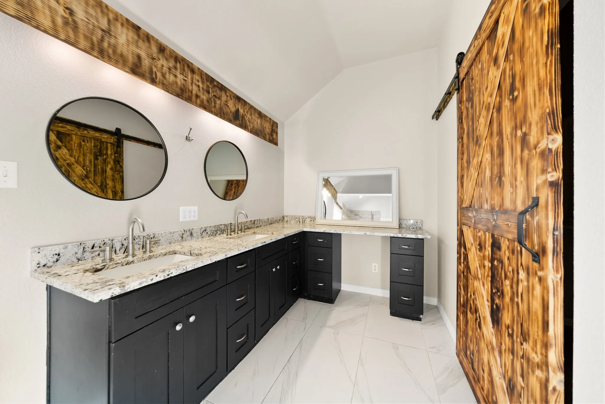 Dual vanity with granite countertops, undermount sinks, and dark wood cabinetry