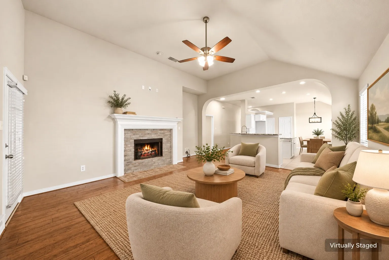 Vaulted ceiling with a ceiling fan, stone-surround fireplace with a mantel, wood-finish flooring, and recessed lighting