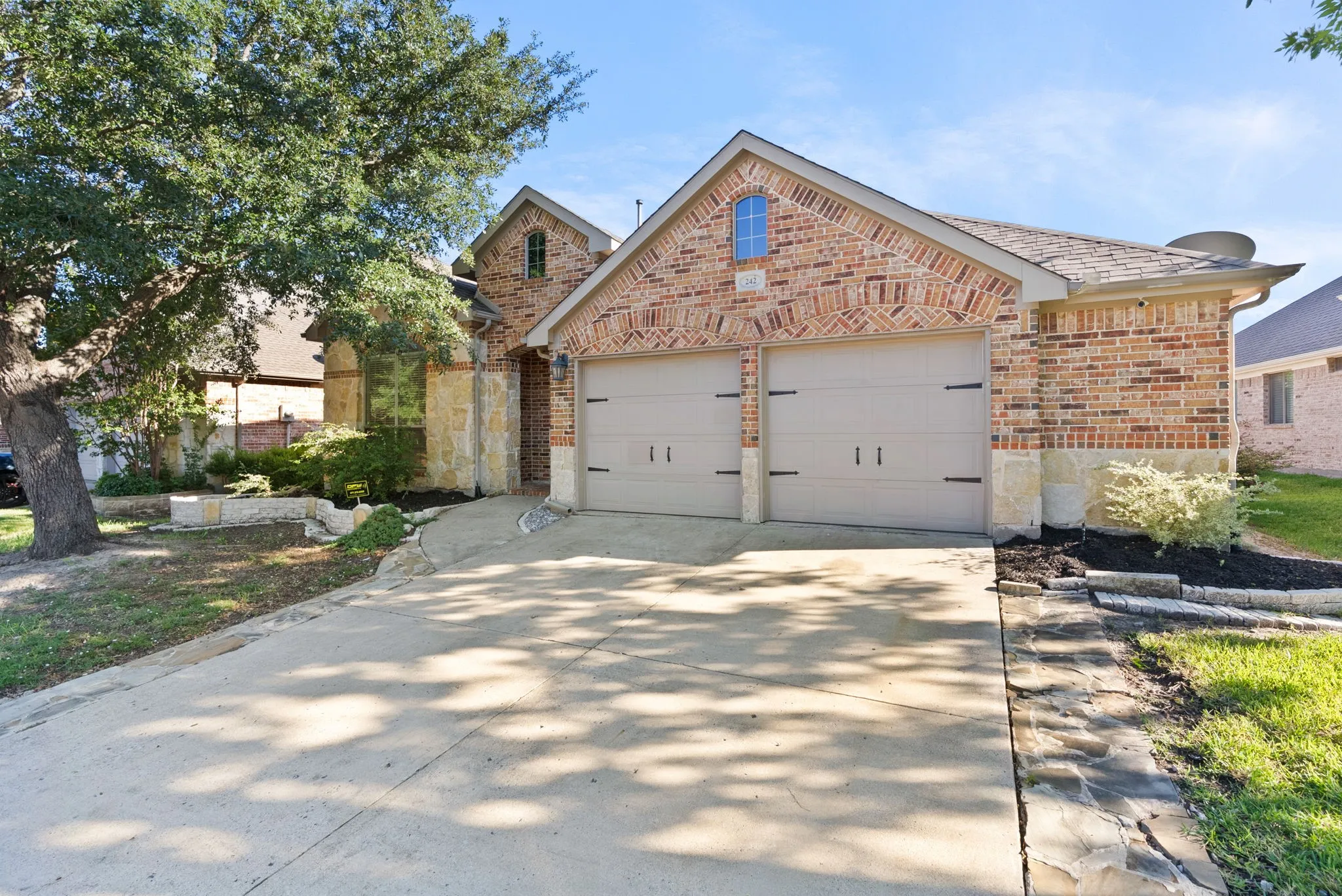 Brick exterior with architectural detailing and arched entryway