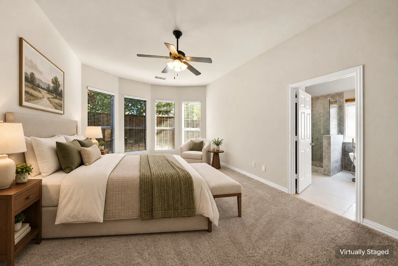 Vaulted ceiling with a ceiling fan, bay windows with blinds, plush carpeting, and an adjoining bath with tiled flooring