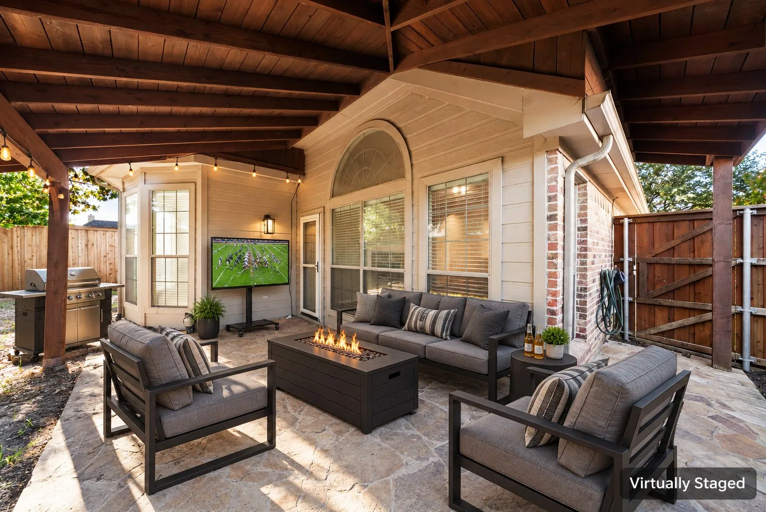 Covered outdoor patio featuring a wood ceiling and string lights