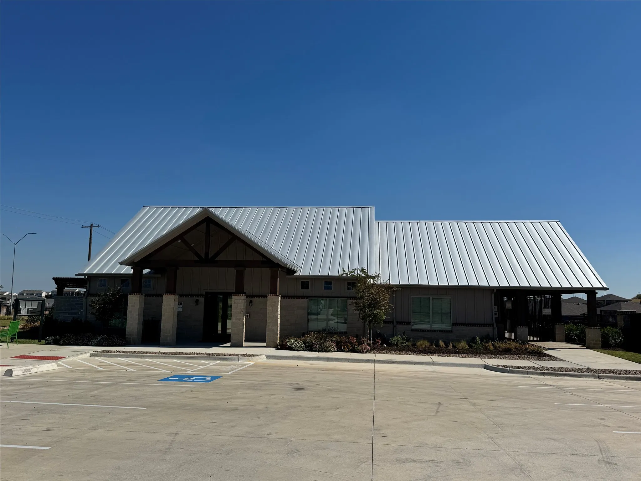 View of building exterior featuring uncovered parking