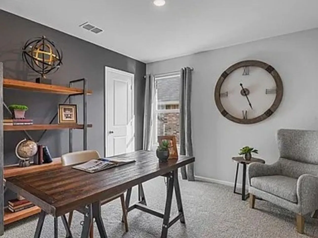 Bedroom staged as a Home office featuring light carpet and recessed lighting.  Currently home is vacant and this room no longer has the accent wall color.