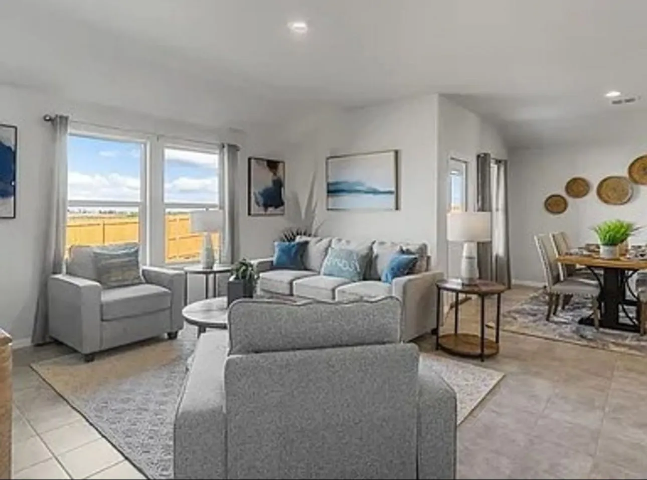 Staged Living room featuring healthy amount of natural light, light tile patterned floors, and recessed lighting