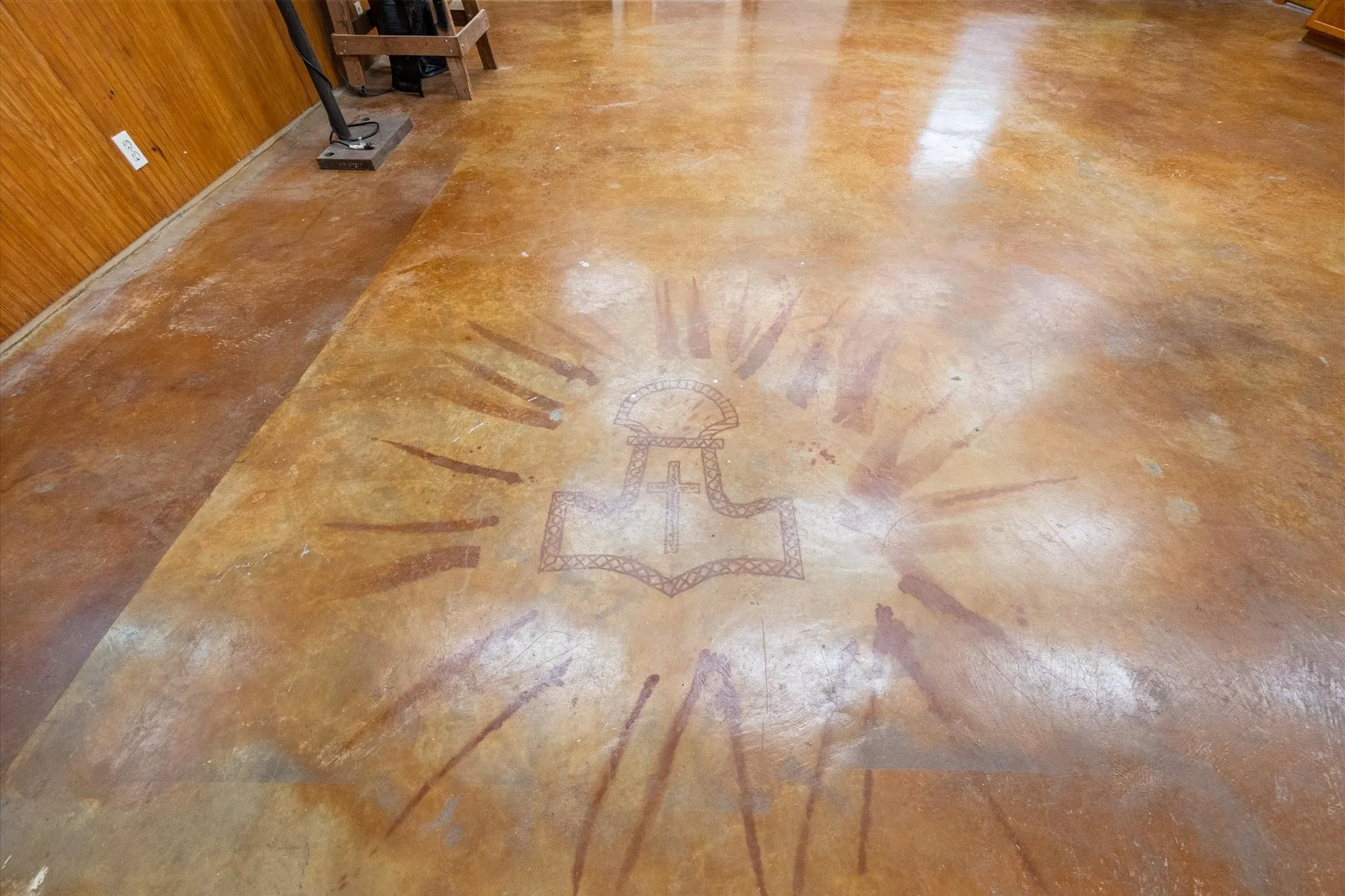 Polished concrete flooring with a distinct central medallion design
