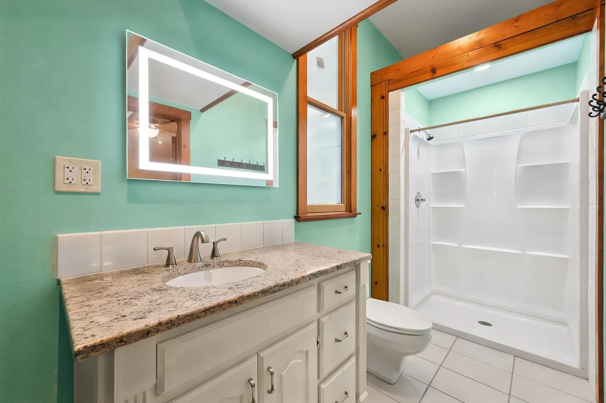 Vanity with stone-finish countertop, undermount sink, and brushed nickel faucet