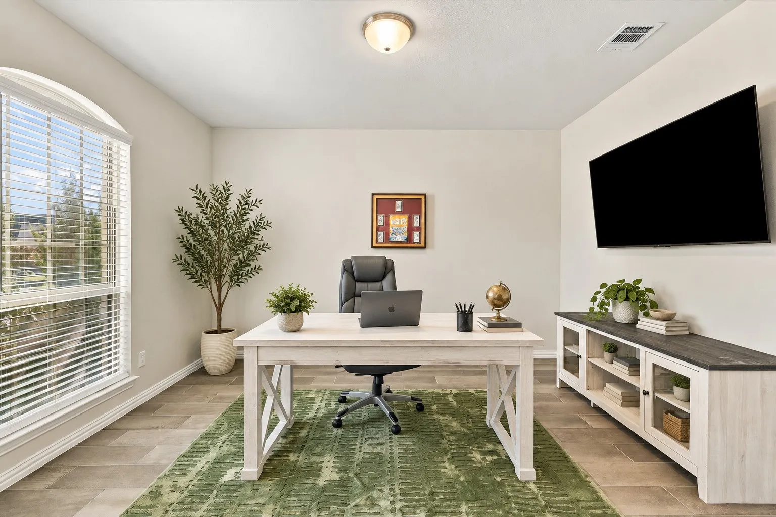 Arched window with blinds, recessed ceiling light, wall-mounted display, and tile flooring