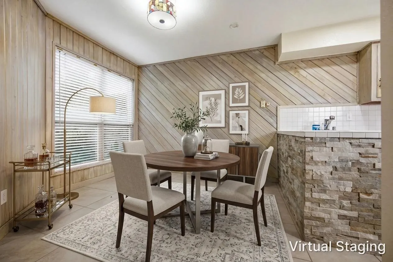 Accent wall paneling with a light wood finish, large window with blinds, tile flooring, and a stone-clad half-wall