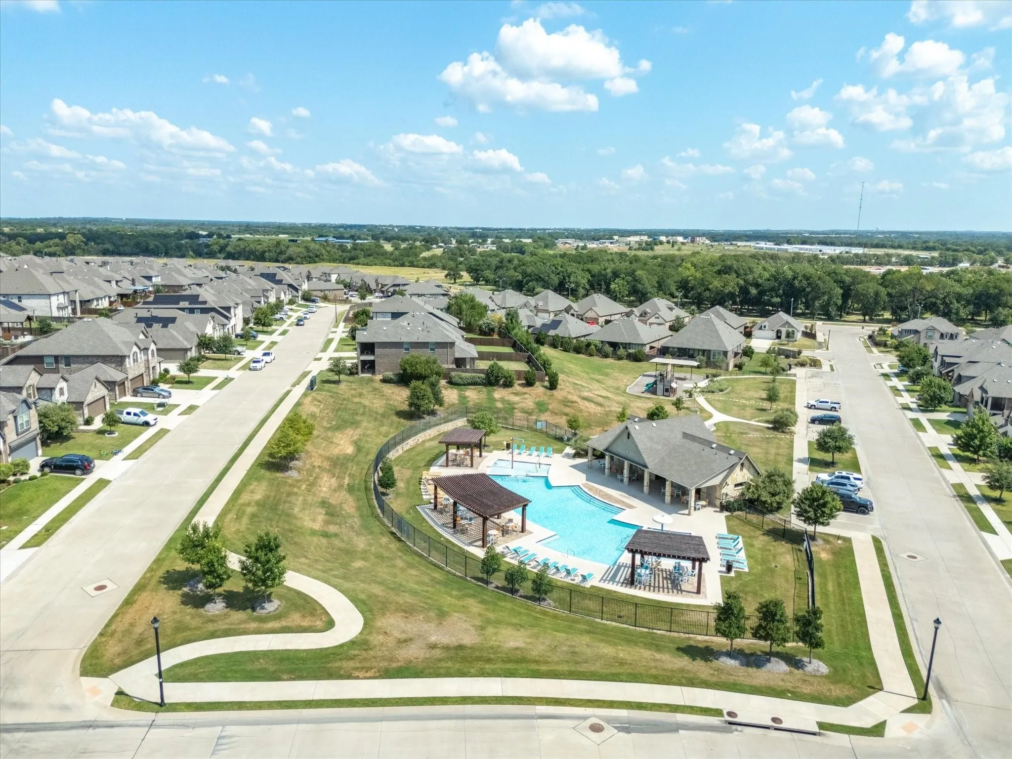 Community features an outdoor pool, covered lounge areas, and expansive green spaces